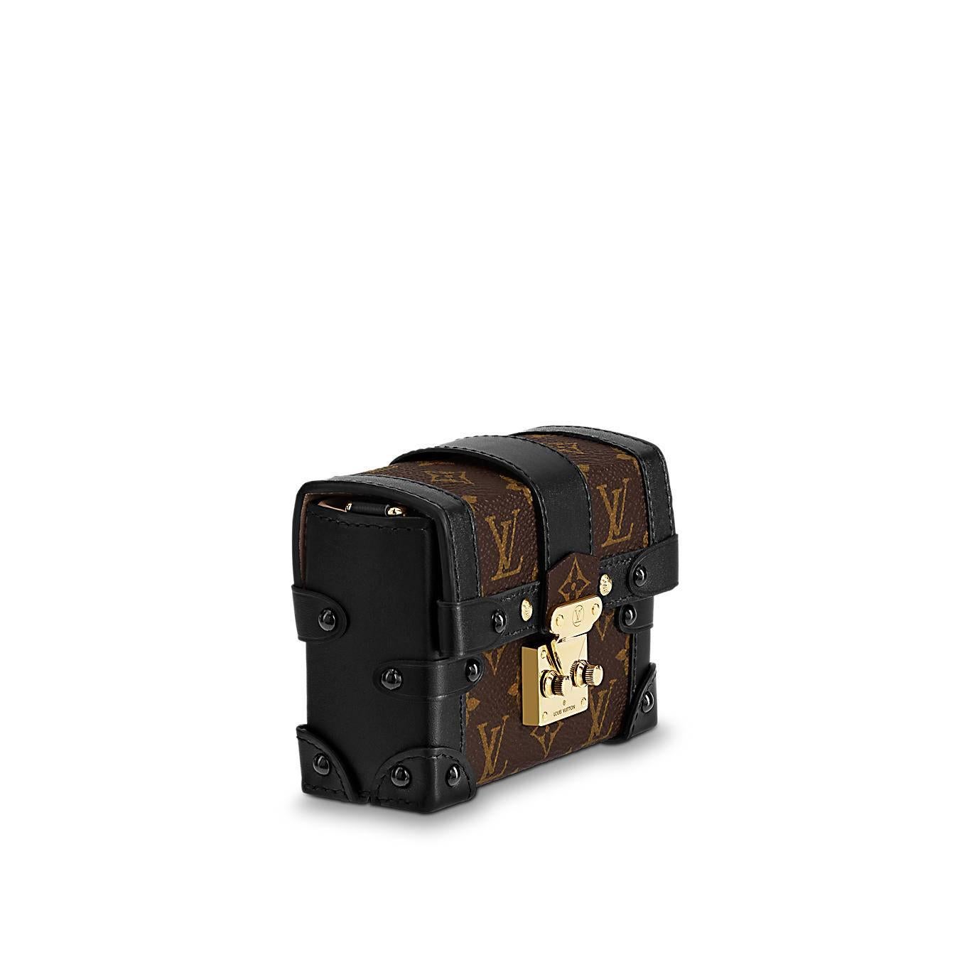 A miniature version of Louis Vuitton's iconic Petite Malle, replicating key details of the historic trunks, the Essential Trunk is the most elegant way to carry a few precious essentials. Its removable chain offers different carry options, while it
