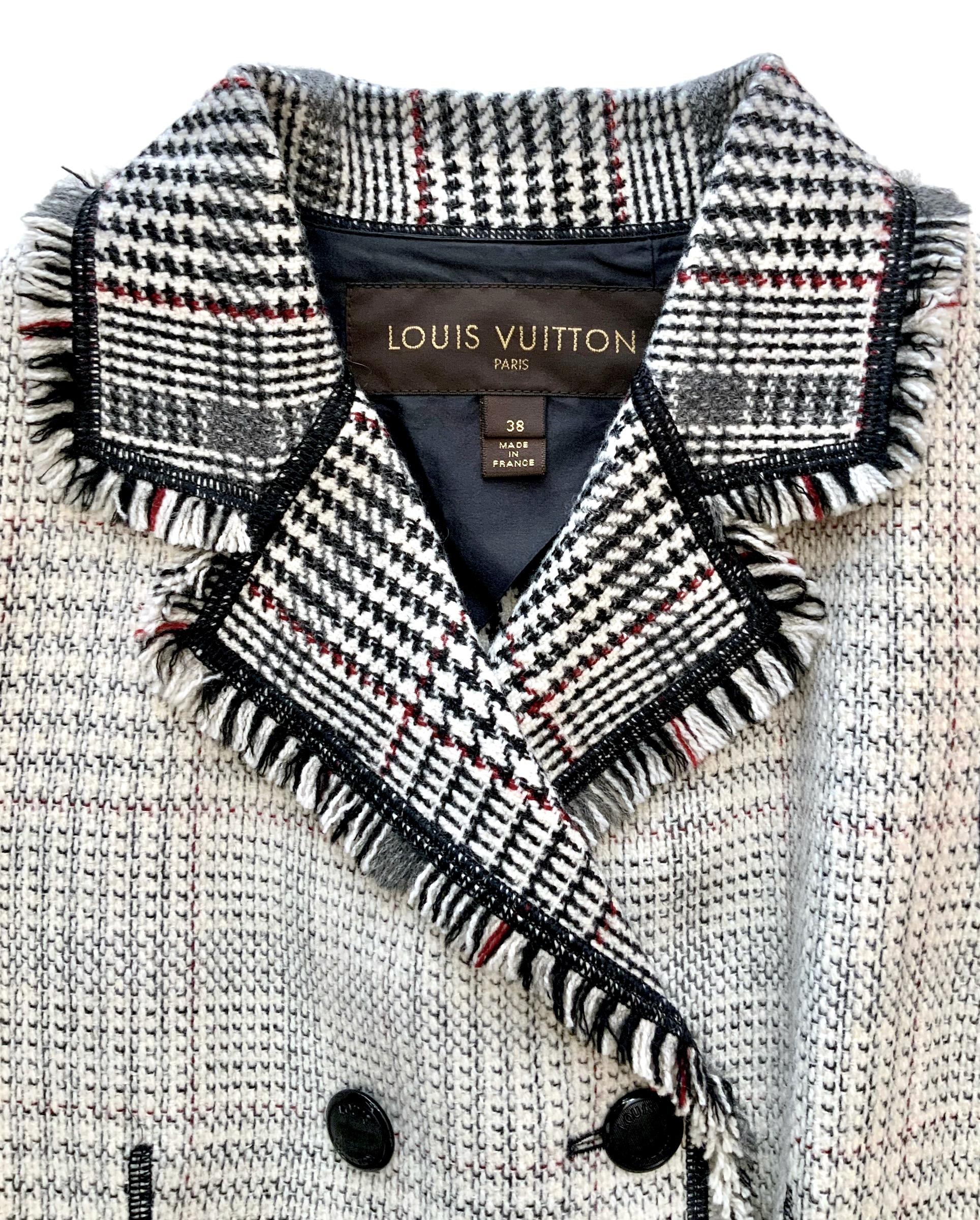 Very interesting jacket from the house of Louis Vuitton.
Crafted in a single layer of a light weight wool with a Prince of Wales check pattern in a light cream tones on the outside and black, burgundy and grey tones on the inside.
The collar and