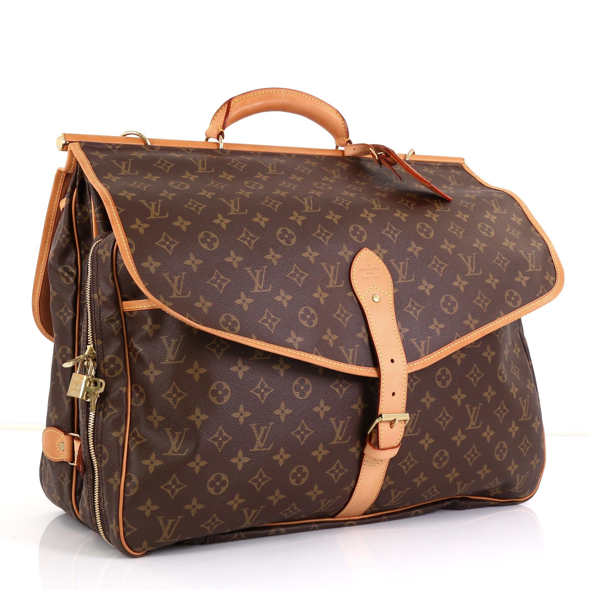 This Louis Vuitton Sac Chasse Hunting Bag Monogram Canvas, crafted in brown monogram coated canvas, features rolled leather top handle with vachetta rod, flat pockets under each flap, and gold-tone hardware. Its buckle and zip closures on both sides