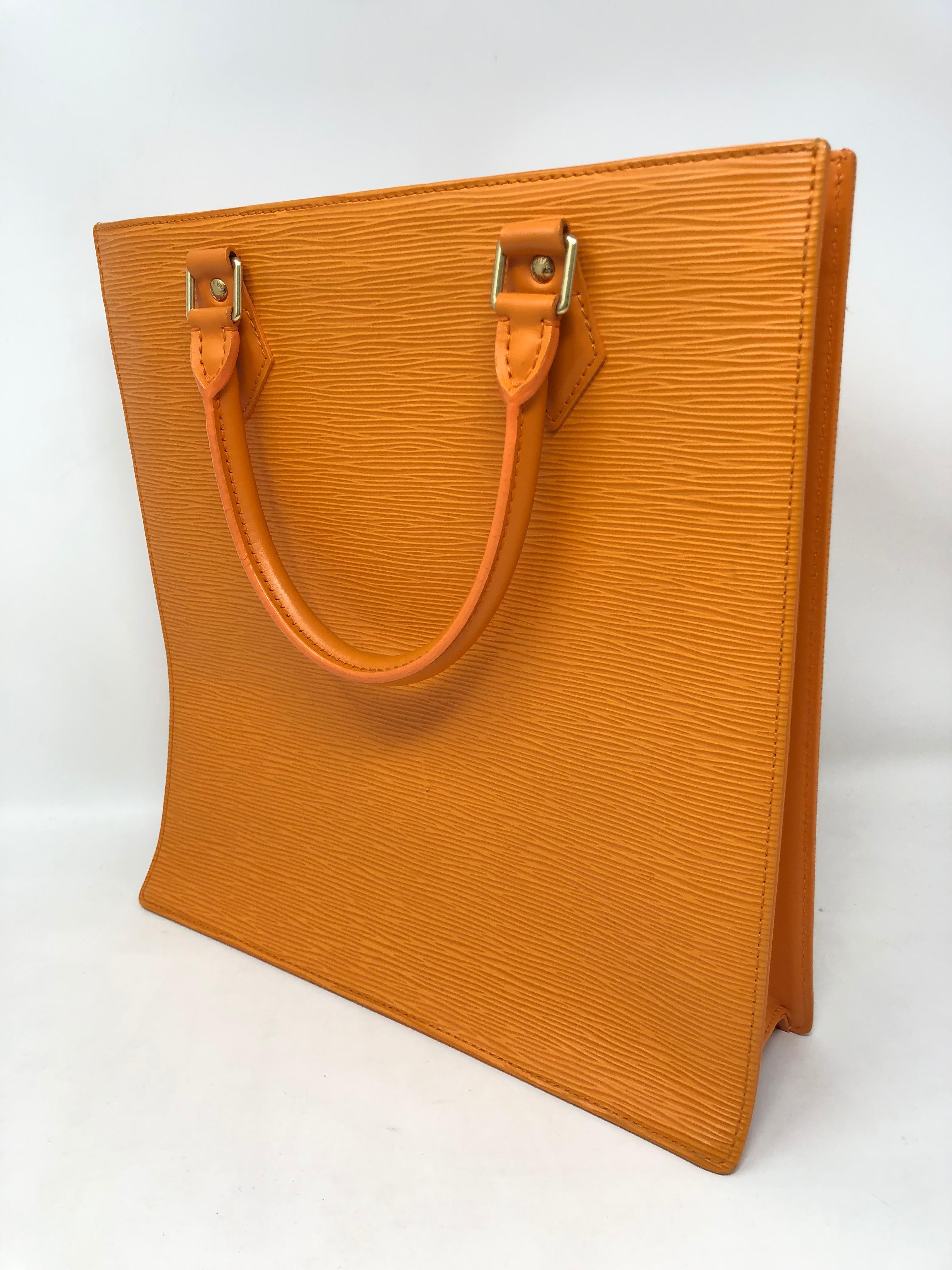 Louis Vuitton Orange Sac Plat in Epi leather. Retired Sac Plat is one of our favorite totes. Larger documents and smaller laptop can be carried inside. Beautiful orange epi leather and orange fabric interior. Like new condition. Initials are hot