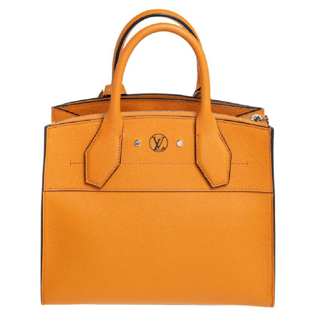 This opulent City Steamer PM bag by Louis Vuitton will ensure a harmonious mix of utility and classic appeal. Crafted from leather, it features a spacious interior, dual top rolled handles, and a detachable shoulder strap for hands-free days. This