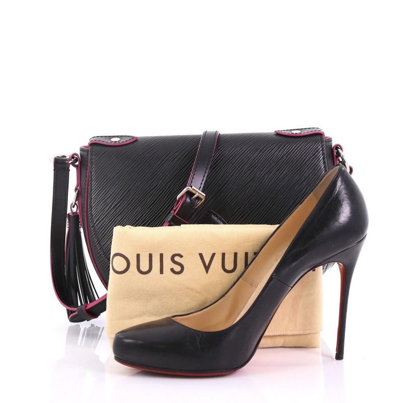 This Louis Vuitton Saint Cloud Handbag NM Epi Leather, crafted in black epi leather, features a long adjustable cross-body strap, front flap with metallic buckle, leather tassel at side, and silver-tone hardware. It opens to a pink microfiber