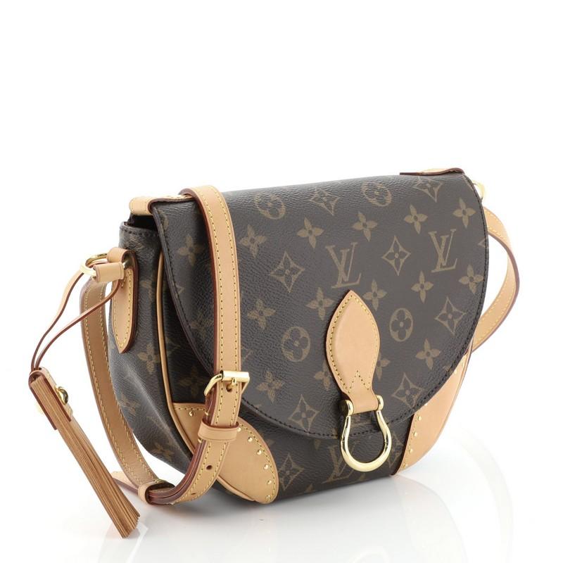 This Louis Vuitton Saint Cloud NM Bag Monogram Canvas, crafted in brown monogram coated canvas, features an adjustable cross-body strap, vachetta leather trim, front flap with buckle, leather tassel, and gold-tone hardware. Its snap button closure