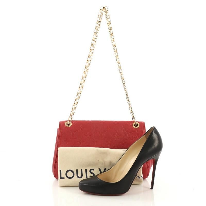 This Louis Vuitton Saint Germain Handbag Monogram Empreinte Leather PM, crafted from red monogram empreinte leather, features chain-link shoulder strap and gold-tone hardware. Its S-lock closure opens to a red microfiber interior with zip pocket.