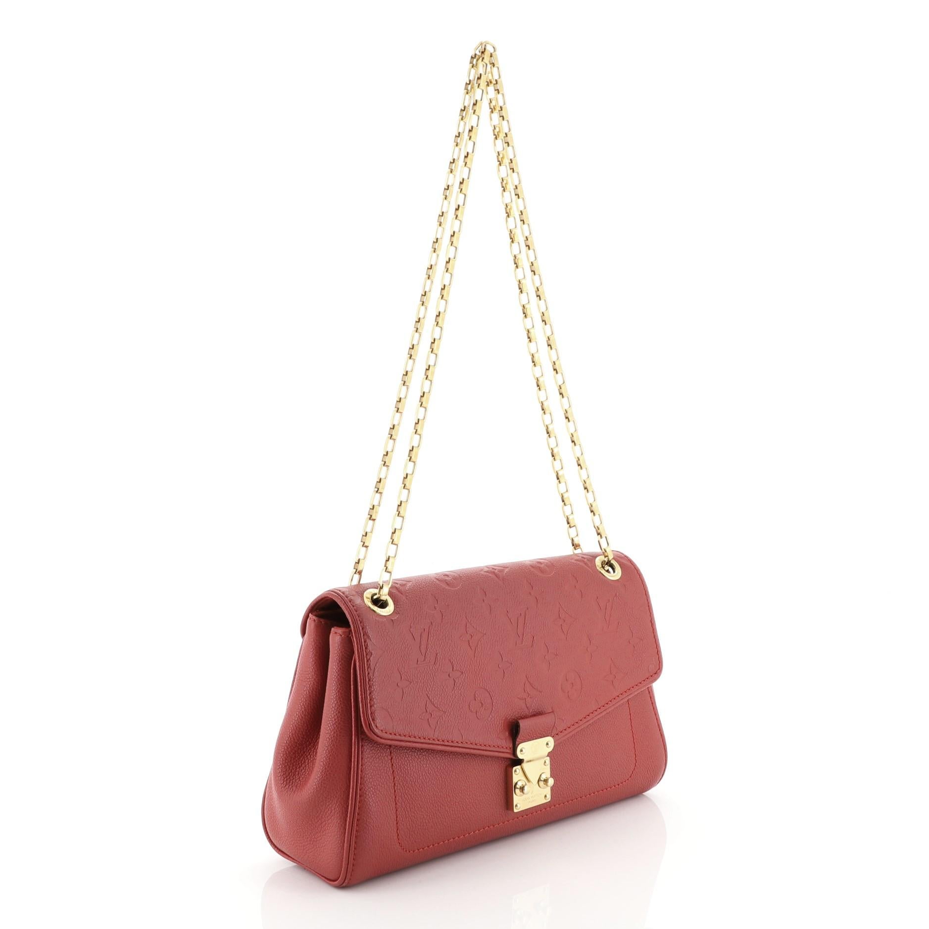 This Louis Vuitton Saint Germain Handbag Monogram Empreinte Leather PM, crafted from red monogram empreinte leather, features chain link shoulder strap and gold-tone hardware. Its S-lock closure opens to a red microfiber interior with zip pocket.