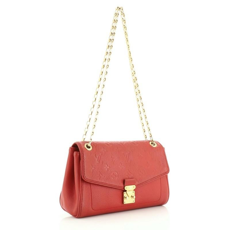 This Louis Vuitton Saint Germain Handbag Monogram Empreinte Leather PM, crafted from red monogram empreinte leather, features chain link shoulder strap and gold-tone hardware. Its S-lock closure opens to a red microfiber interior with zip pocket.