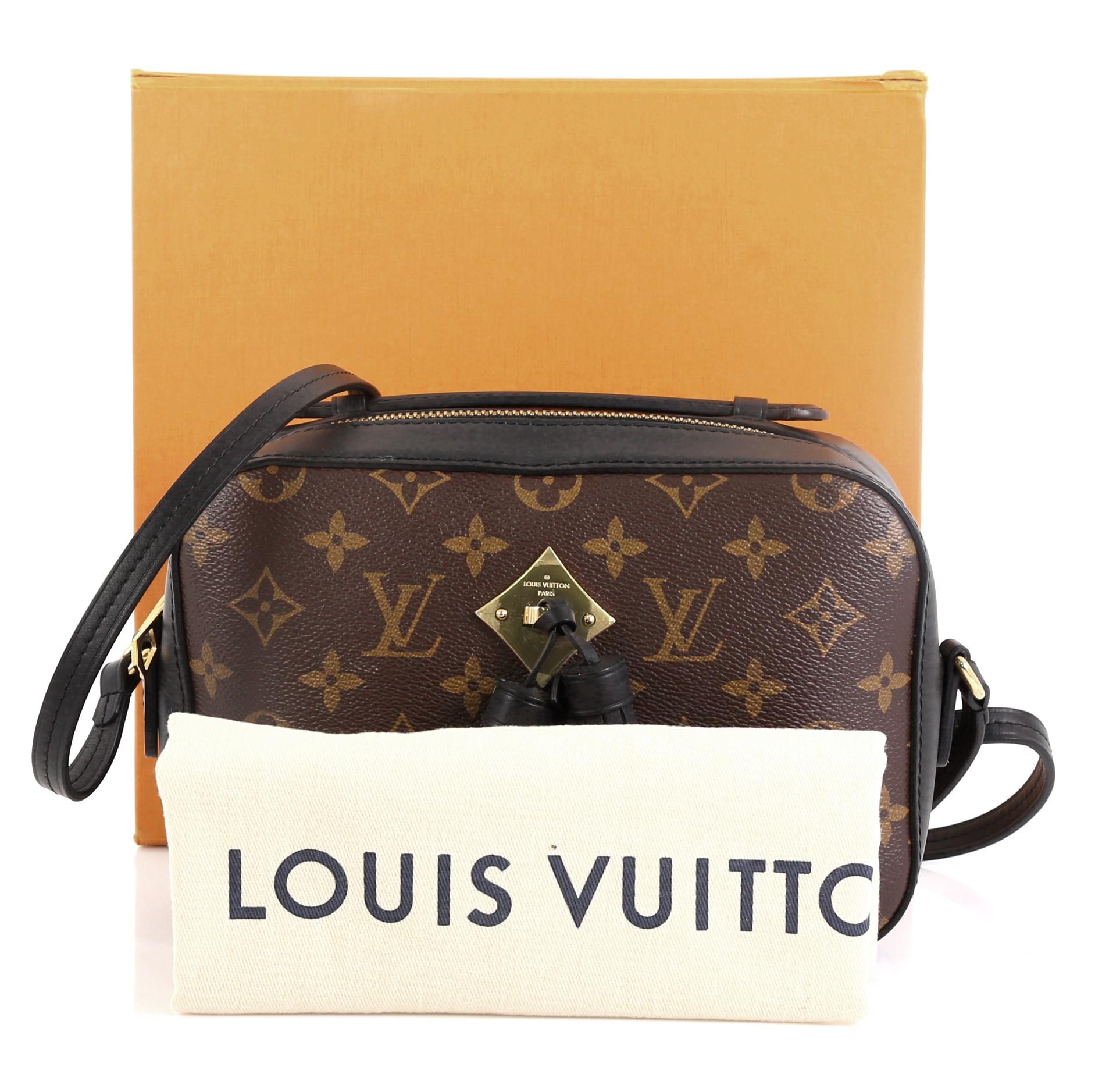This Louis Vuitton Saintonge Handbag Monogram Canvas with Leather, crafted from brown monogram coated canvas with leather, features top handle and long strap, leather tassels and gold-tone hardware. Its zip closure opens to a black fabric interior