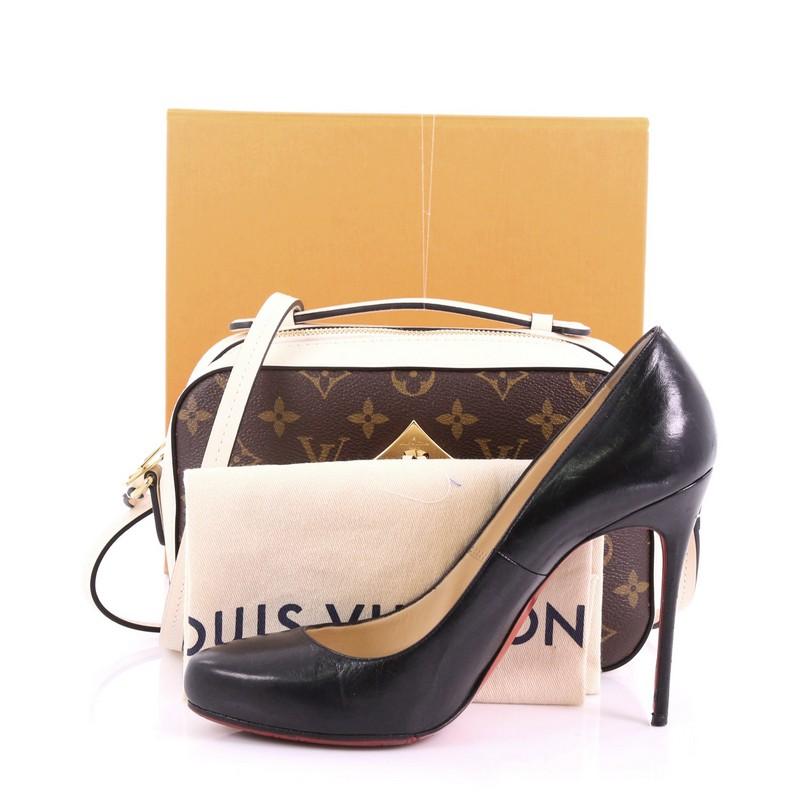 This Louis Vuitton Saintonge Handbag Monogram Canvas with Leather, crafted from brown monogram coated canvas with beige leather, features top handle and long strap, leather tassels and gold-tone hardware. Its zip closure opens to a beige fabric