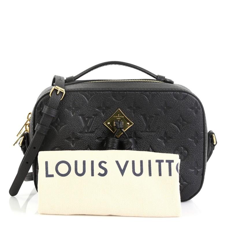 This Louis Vuitton Saintonge Handbag Monogram Empreinte Leather, crafted from black monogram empreinte leather, features top handle and adjustable strap, leather tassels and gold-tone hardware. Its zip closure opens to a black fabric interior with