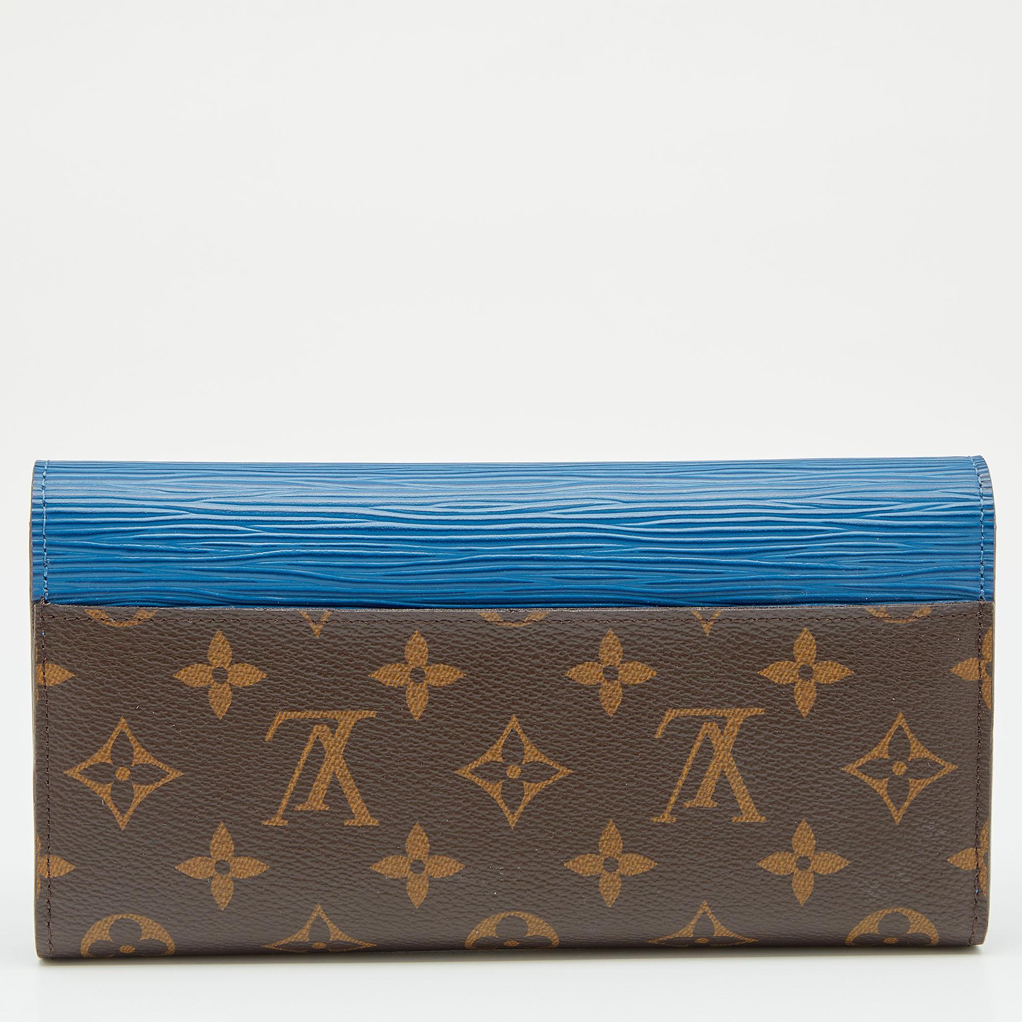 The House of Louis Vuitton creates this beautiful Marie-Lou wallet by incorporating luxurious elements into its structure. Displaying the Monogram canvas and Epi leather on the exterior, this wallet adopts the signature beauty of the brand. The flap