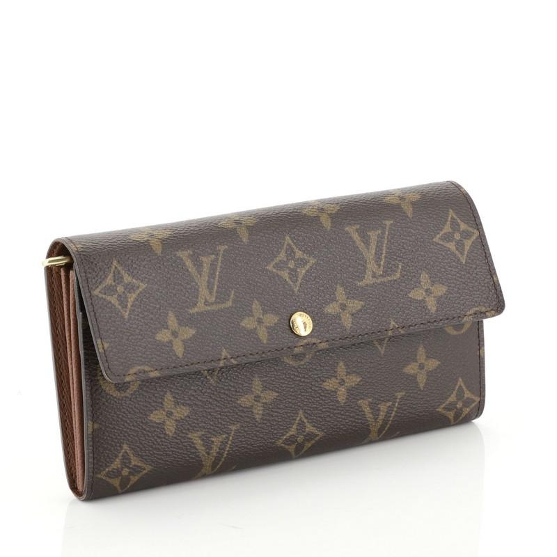 This Louis Vuitton Sarah Wallet Monogram Canvas, crafted from brown monogram coated canvas, features frontal flap and gold-tone hardware. Its snap closure opens to a brown leather interior with multiple card slots and zip compartment. Authenticity