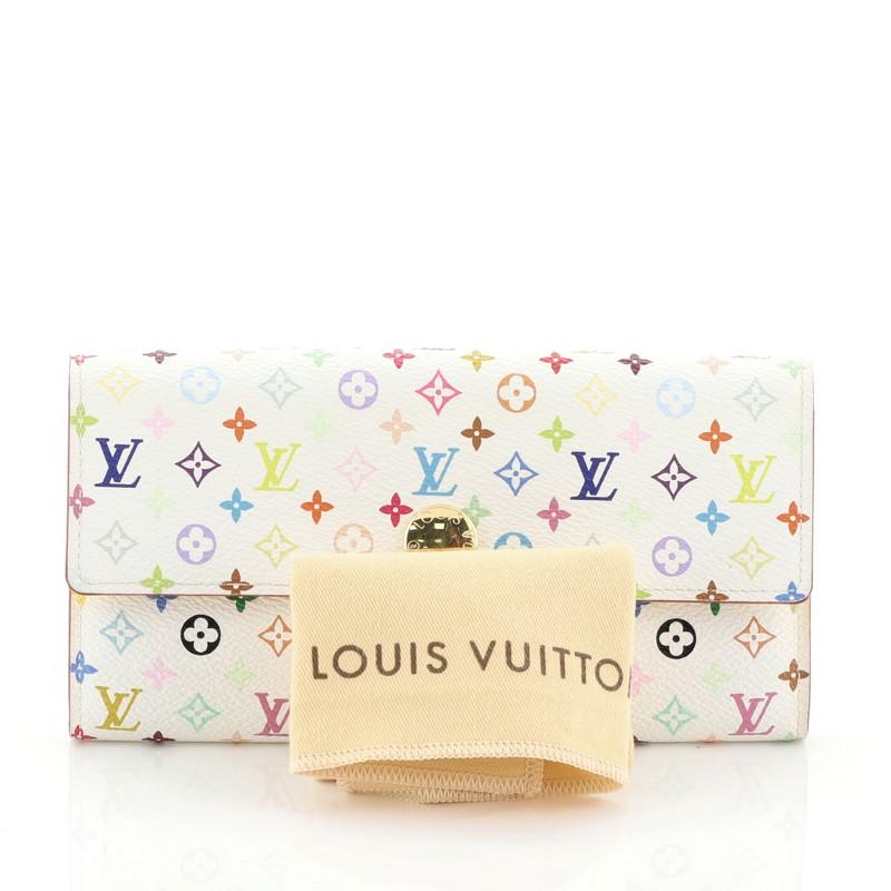 This Louis Vuitton Sarah Wallet Monogram Multicolor, crafted from white monogram multicolor coated canvas, features frontal flap and gold-tone hardware. Its snap closure opens to a yellow leather interior with multiple card slots and zip
