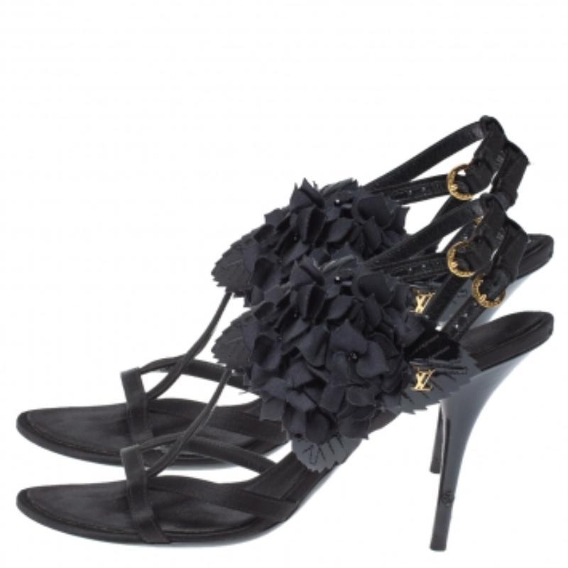 Step out in style with this Louis Vuitton creation. Crafted from satin and patent leather, the sandals feature flower embellishments. Designed as open toes, this pair of sandals comes with leather-lined insoles, stiletto heels and ankle straps with