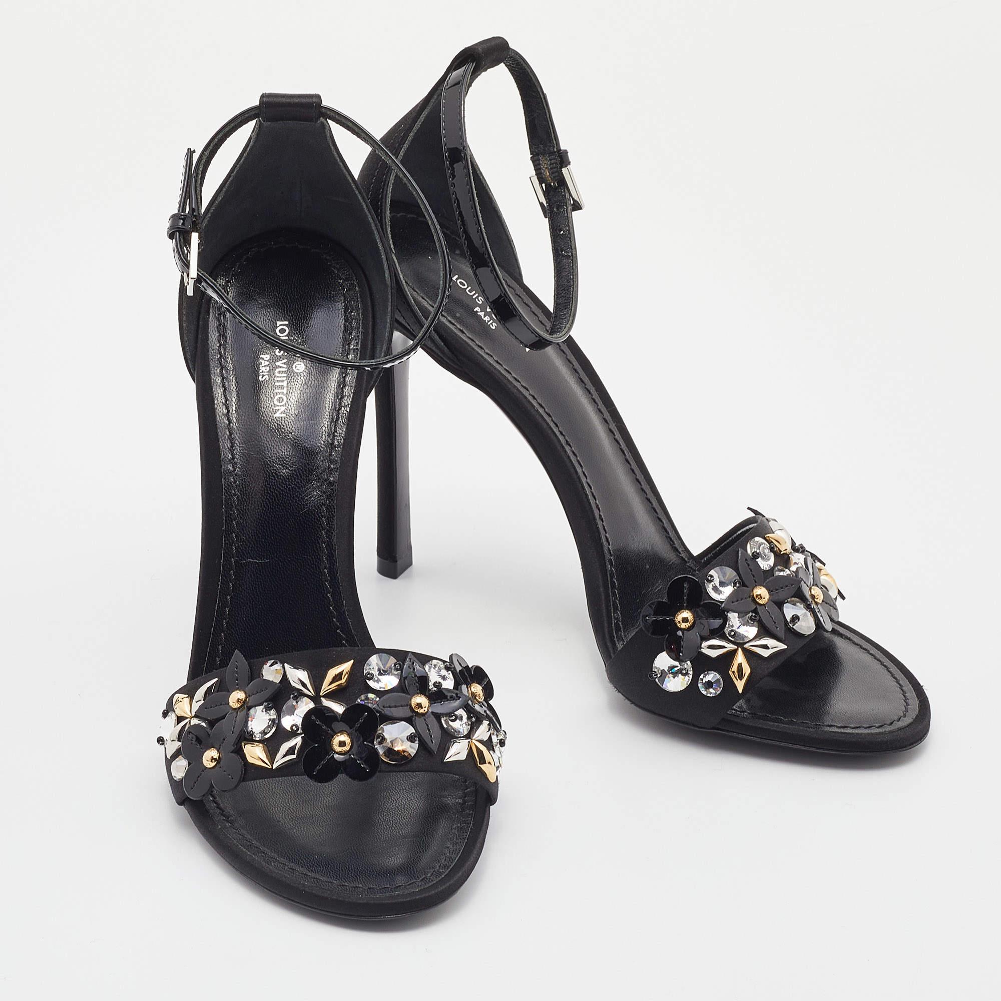These sandals from Louis Vuitton will lend a stylish and glamorous edge to your feet. This beautiful pair is made of satin as well patent leather and added with embellished straps, buckled ankle closure, and 11.5 cm heels.

