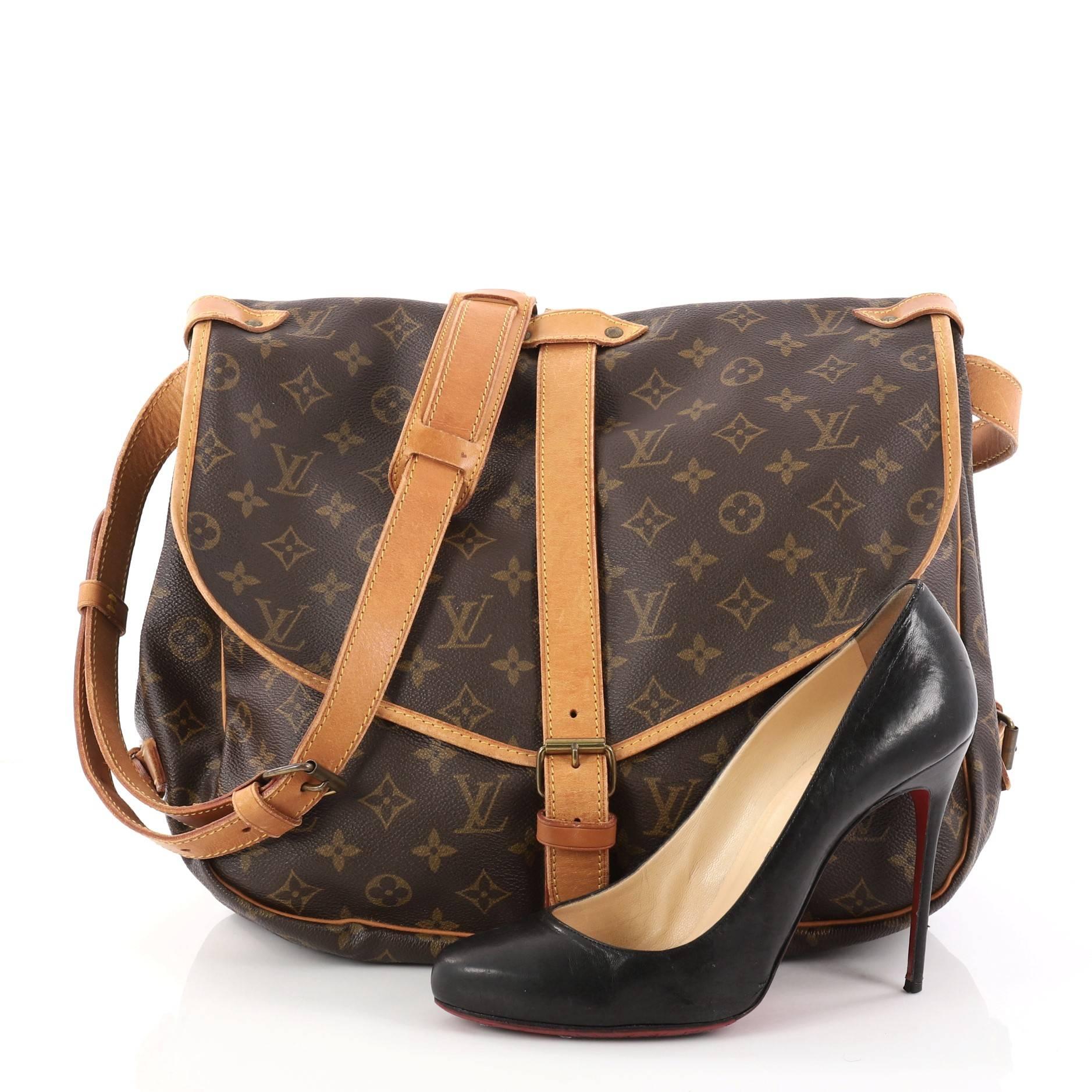 This authentic Louis Vuitton Saumur Handbag Monogram Canvas GM showcases the brand's reinterpretation of the classic saddle bag. Crafted in Louis Vuitton's popular brown monogram coated canvas, this bag features long adjustable shoulder strap,