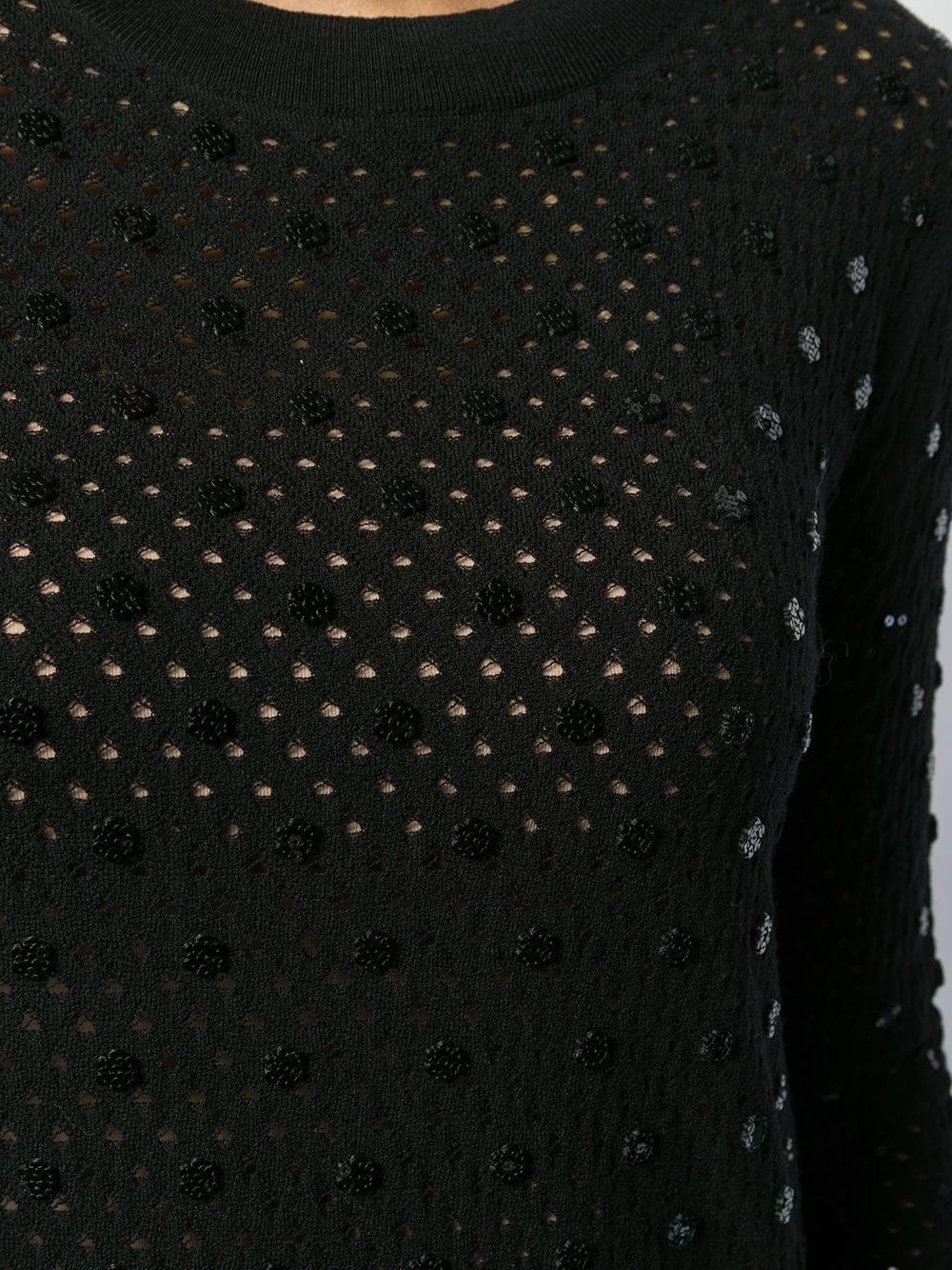 Fabriqué de manière experte en Italie à partir d'un mélange complexe de laine et de polyester noirs, cet élégant pull d'occasion Louis Vuitton présente des manches longues, un col ras du cou et des détails côtelés. Le vêtement présente un design à
