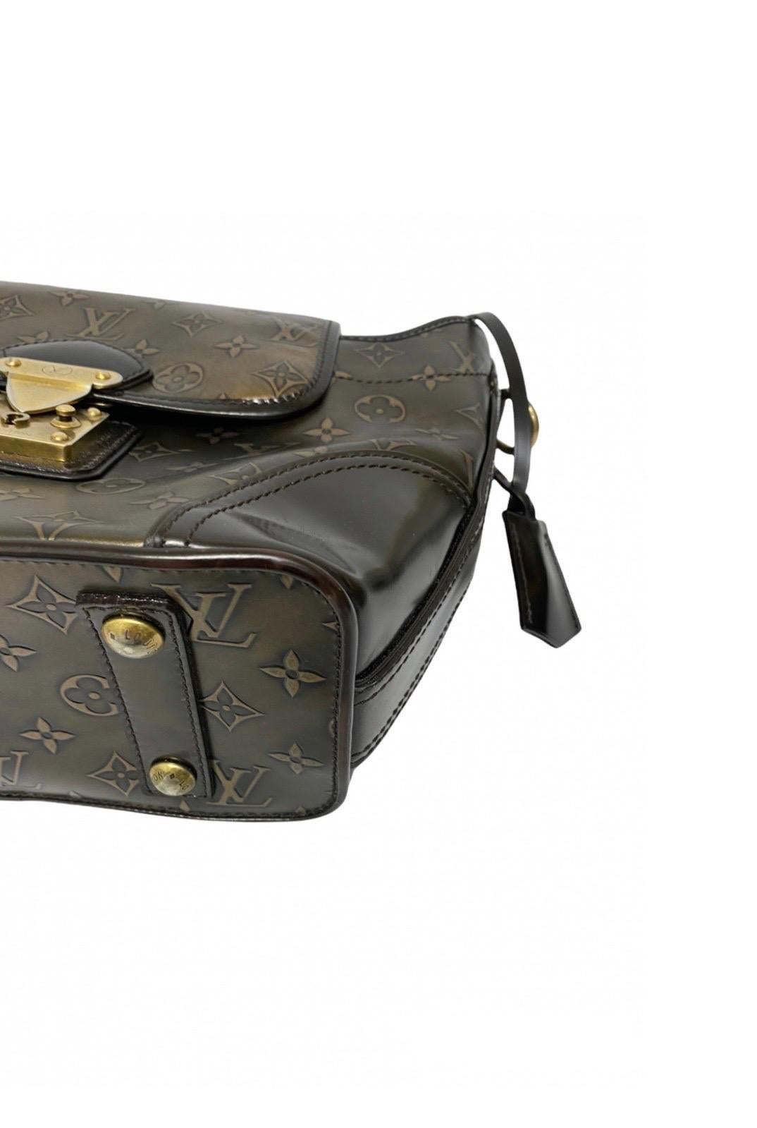 From the 2007 Prefall collection this super chic Louis Vuitton Sergent PM model bag features the classic Monogram on antiqued bronzed leather with metal engravings with deep chocolate leather trim with golden hardware. The military-inspired bag