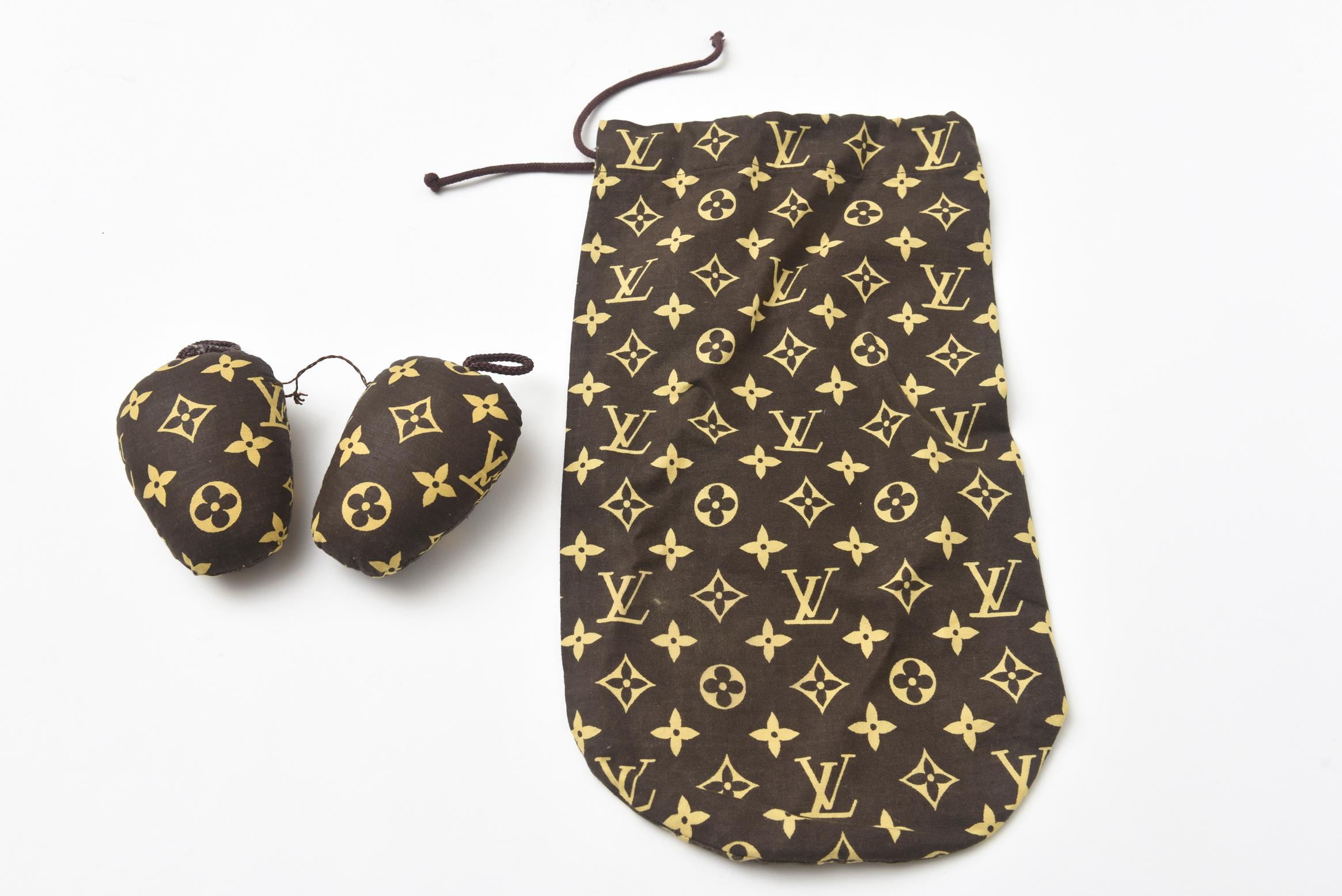This vintage pair of Louis Vuitton glazed canvas 1970's shoe cover and pair of shoe stuffers are so iconic. These are no longer made for a long time. They have never been used. They are perfect for chic travel now for a woman. The bag size is 13.5