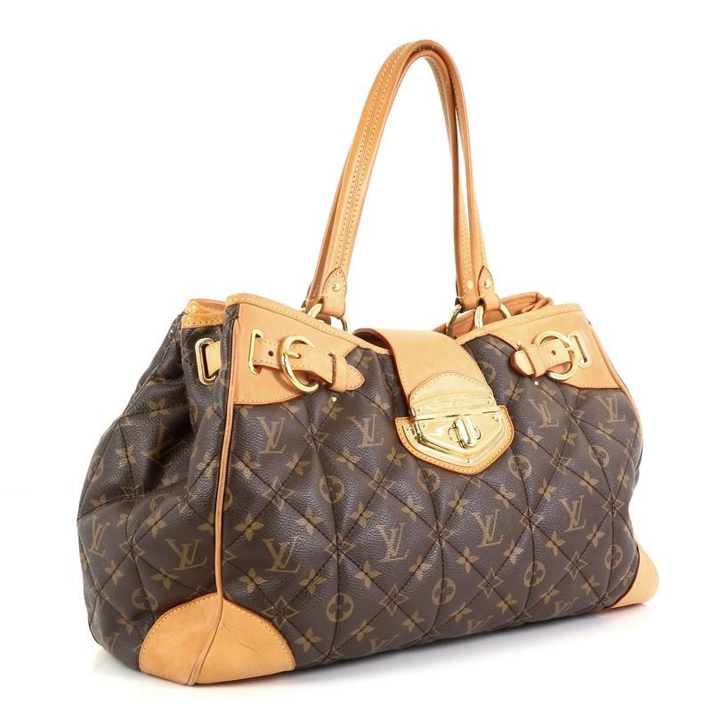 This Louis Vuitton Shopper Monogram Etoile, crafted from quilted brown monogram coated canvas, features dual-flat leather handles, buckle details, protective base studs and gold-tone hardware. Its flap tab and turn-lock closure opens to a neutral