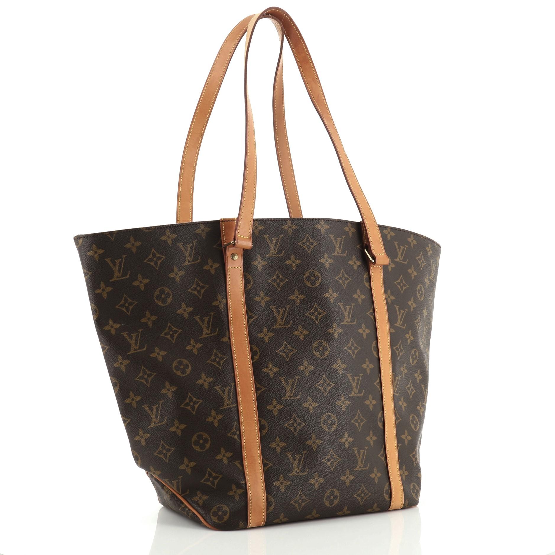 This Louis Vuitton Shopping Sac Handbag Monogram Canvas MM, crafted with brown monogram coated canvas, features dual tall vachetta leather straps and gold-tone hardware. It opens to a brown fabric interior with zip pocket. Authenticity code reads: