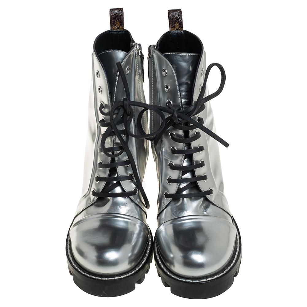 How stylish, modern, and chic do these ankle boots from Louis Vuitton look! They are crafted from silver leather featuring round toes, lace-ups on the vamps, a V logo, comfortable leather-lined insoles, and high block heels. Pair them with smart