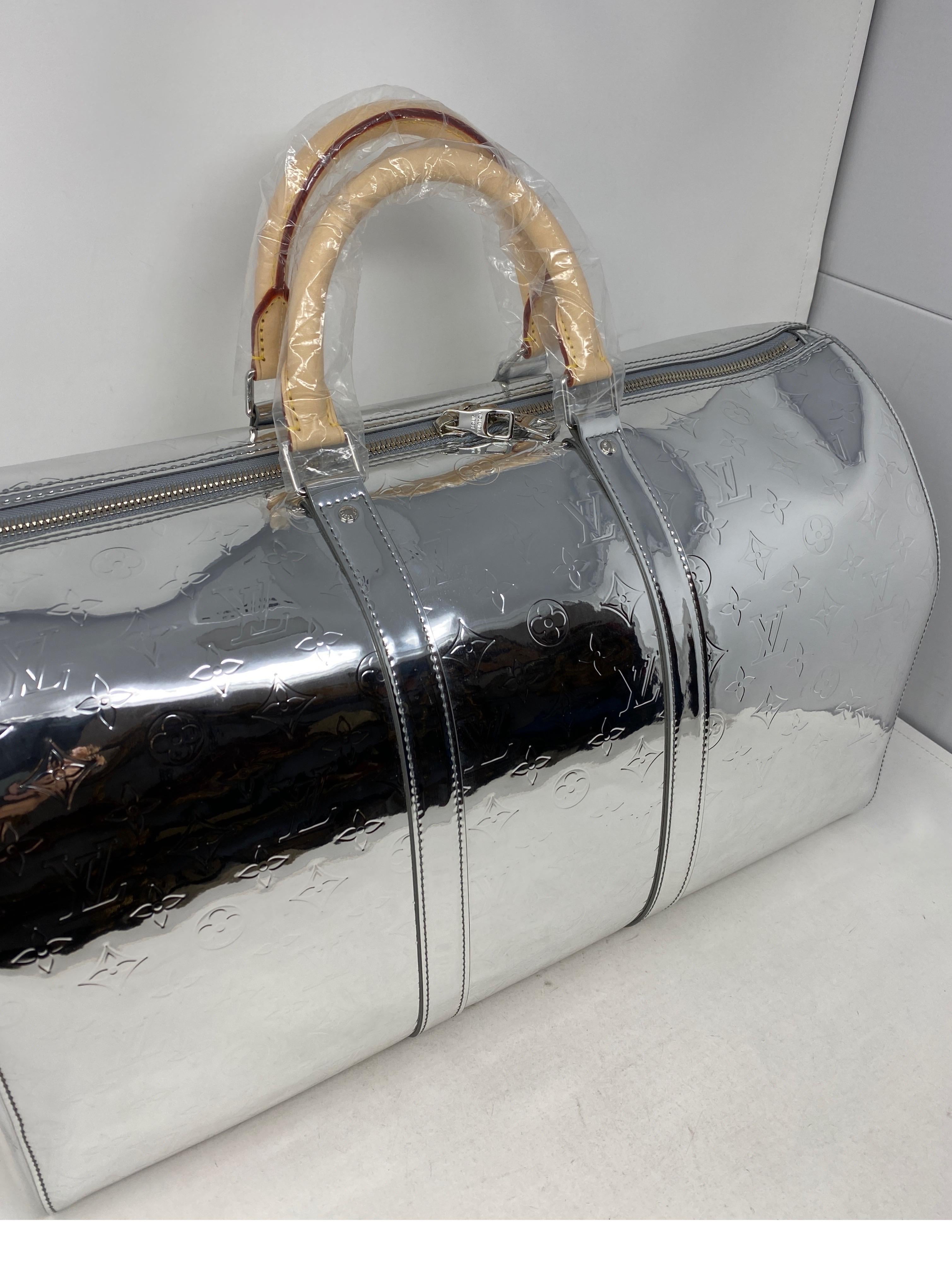 Louis Vuiton Silver Mirrored Virgil Abloh Keepall Bandouliere. Brand new. Rare and limited. Silver monogram  reflects and can be worn with or without strap. Collector's piece. Includes the leather tags and all accessories pictured. Don't miss out.