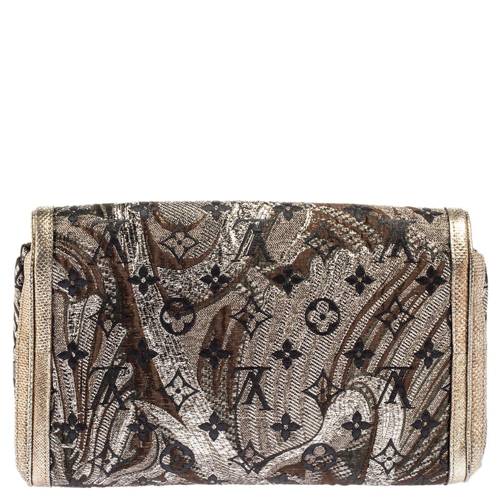 This clutch by Louis Vuitton is one you will love carrying around. The clutch is made from monogram brocade fabric and karung trim. It is complete with gold-tone hardware and a fabric interior secured by a flap. NOTE: The item may be restricted for