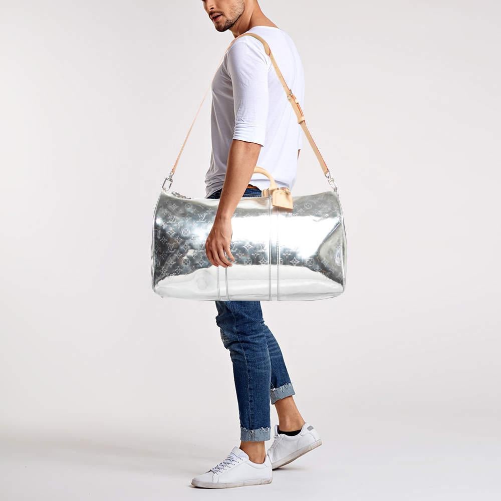 The Louis Vuitton Keepall Bandouliere 50 Bag radiates modern luxury with its striking silver monogram leather. This stylish travel bag features a spacious interior comfortable leather handles and an adjustable shoulder strap for versatile wear. A