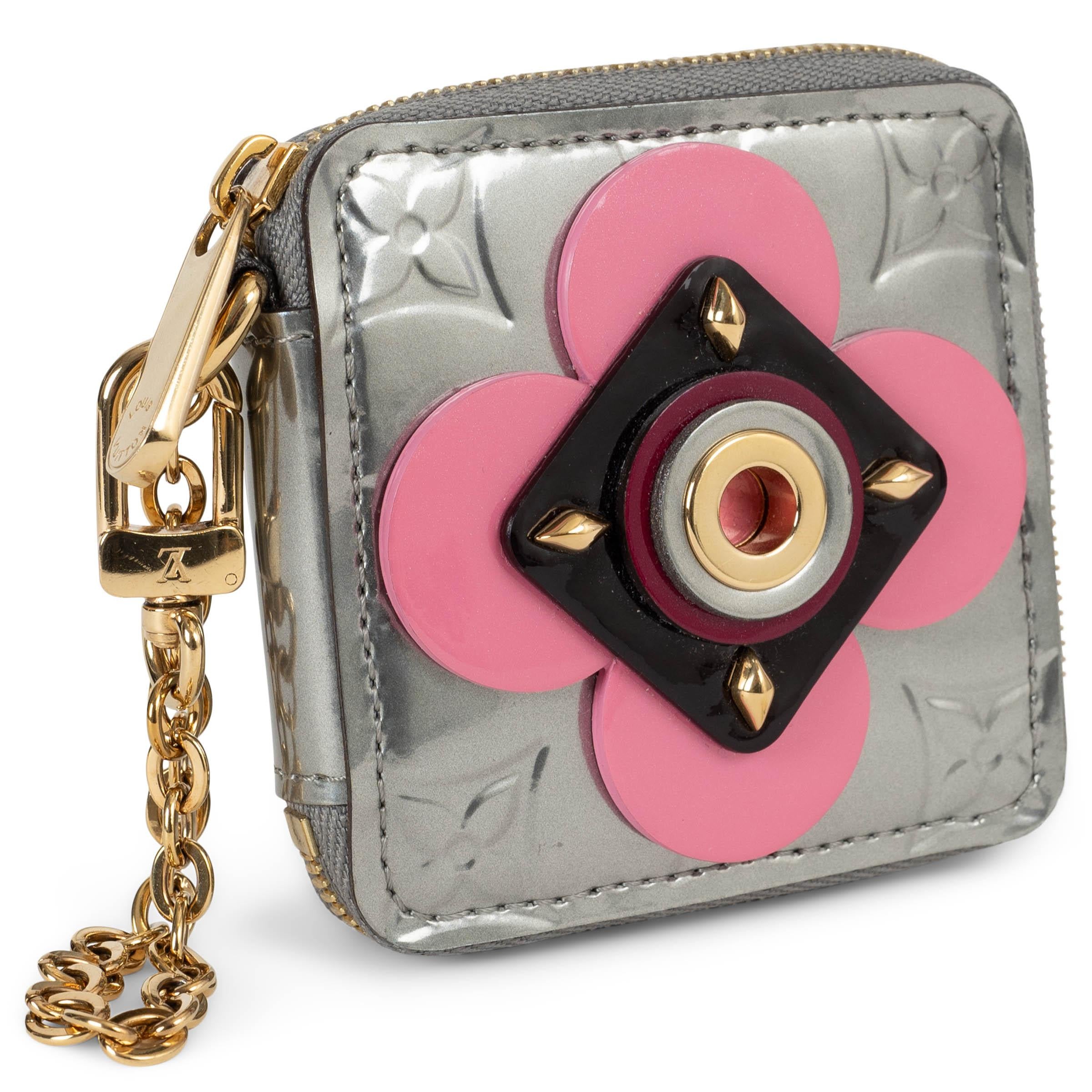 Questo portafoglio portamonete Louis Vuitton Flower Portemonnaie Carré in vernice Gris Art Deco (argento) Monogram Vernis, autentico al 100%, è un accessorio elegante e funzionale. Caratterizzato da fiori decorativi retrò in rosa, ispirati agli