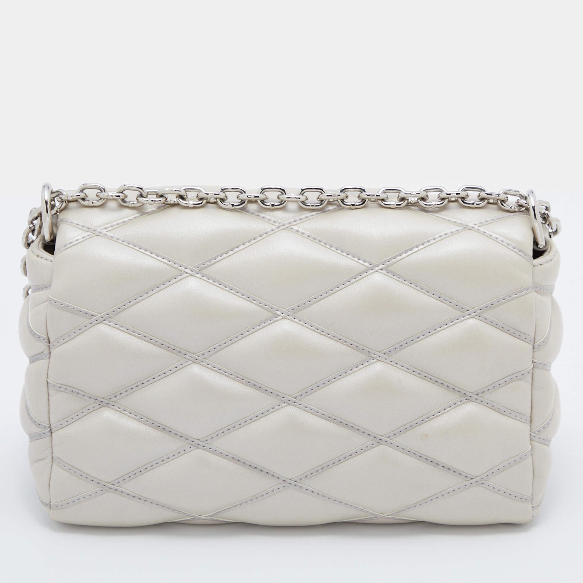 This Louis Vuitton PM bag will be one of your favorite everyday accessories. Expertly made from quilted lambskin leather, it features a chain-leather shoulder strap, silver-tone hardware, and a leather-lined interior. The brand-detailed flap closure