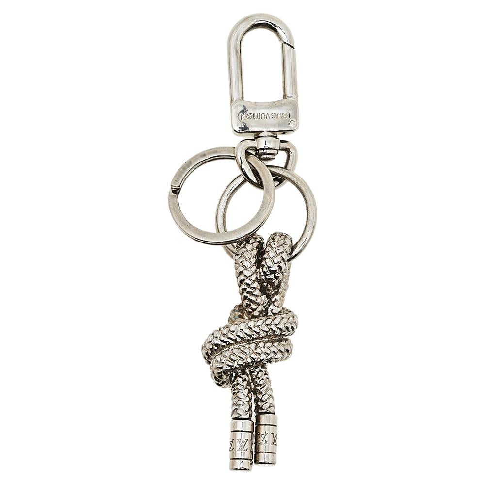 Now you can secure all your keys in this handy yet stylish holder from Louis Vuitton. Made from silver-tone metal, the key holder has a knot detail and a simple clasp for you to hook on your bags.

