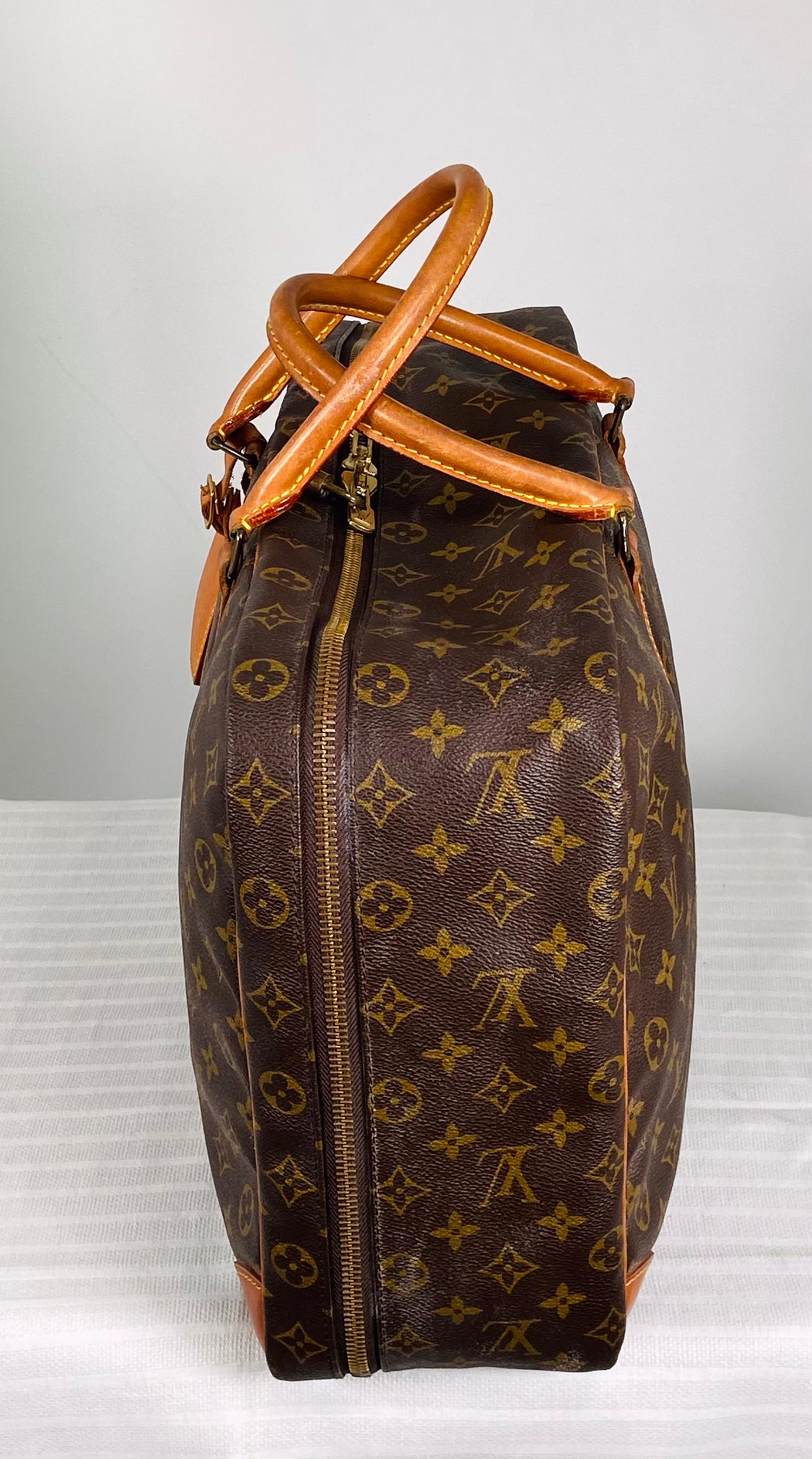 LOUIS VUITTON Sirius 45 carry on, over night, travel bag. Double handle bag has a luggage tag & LV lock but no keys. The outside is in very good pre-owned condition. The interior is clean of a leather like vinyl, with straps to hold down packed