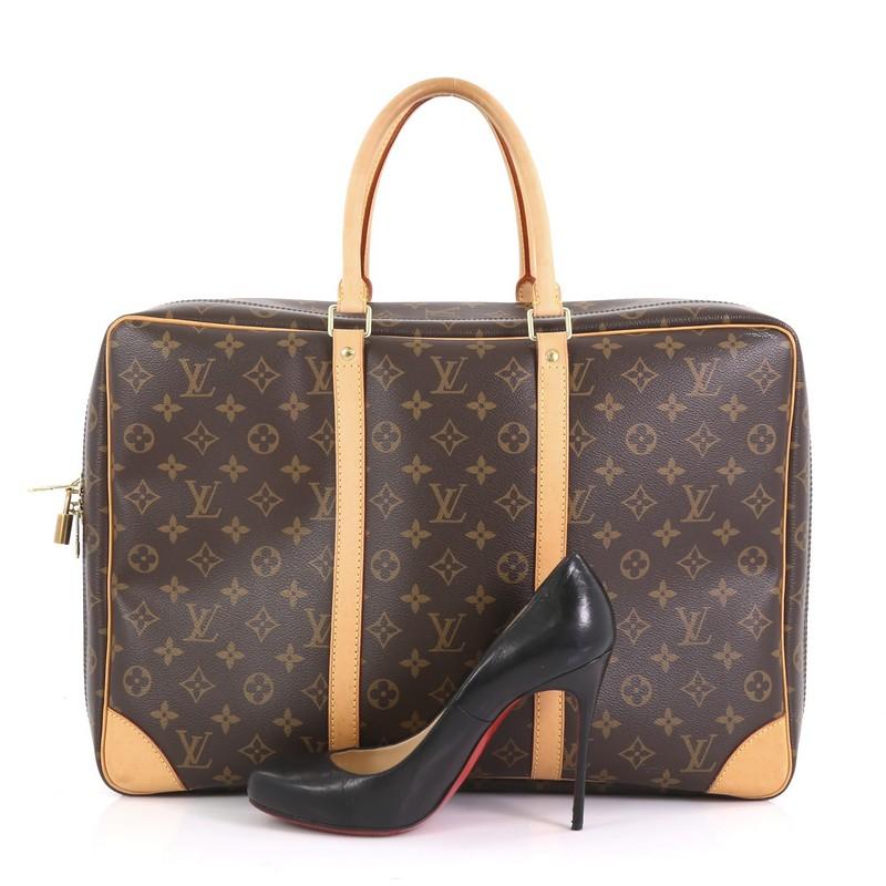 This Louis Vuitton Sirius Handbag Monogram Canvas 45, crafted in brown monogram coated canvas, features natural cowhide vachetta trim, dual rolled top handles, and gold-tone hardware. Its zip closure opens to a beige canvas interior with multiple