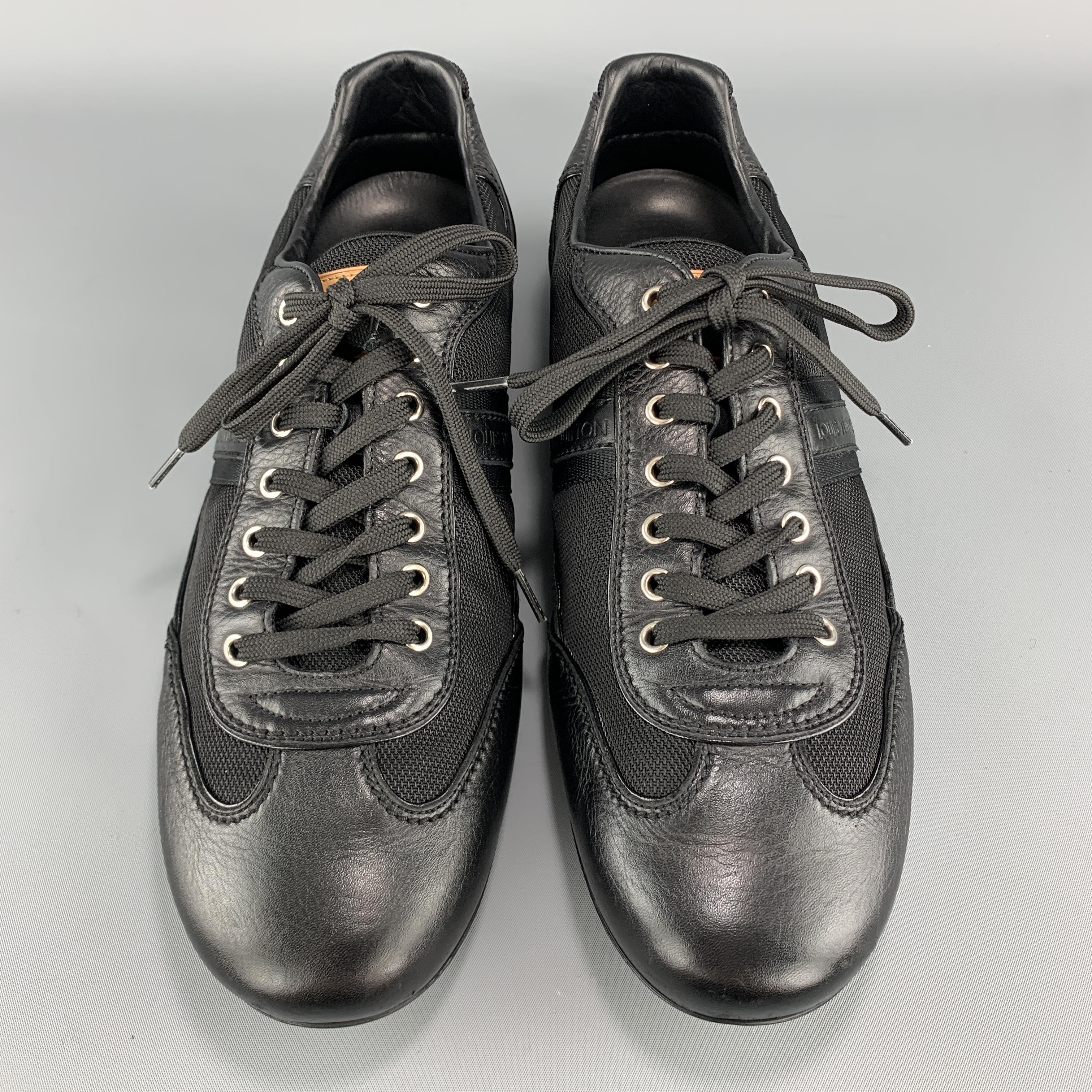 LOUIS VUITTON sneakers come in black canvas with leather details, lace up front, and rubber monogram textured back. Made in Italy.

Excellent Pre-Owned Condition.
Marked: UK 9

Outsole: 12 x 3.5 in.