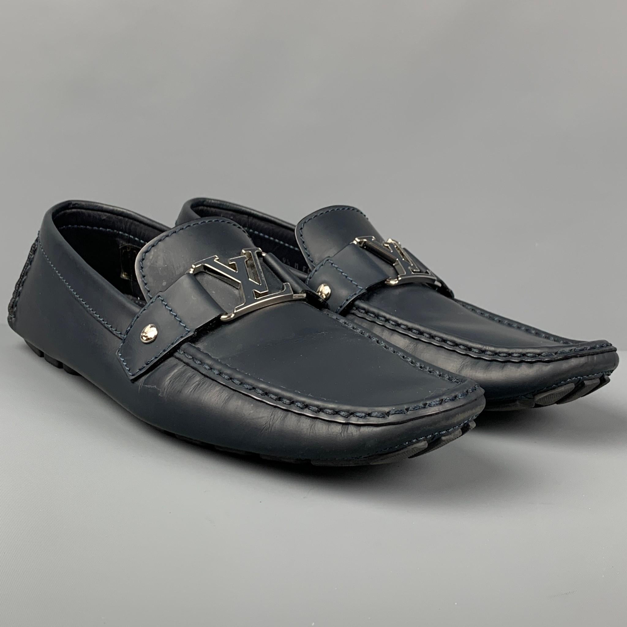 LOUIS VUITTON loafers comes in a navy leather featuring a front 'LV' silver tone metal design, slip on, and a drivers sole. Made in Italy. 

Very Good Pre-Owned Condition.
Marked: 9.5 M FA 0174

Outsole: 12 in. x 4 in. 