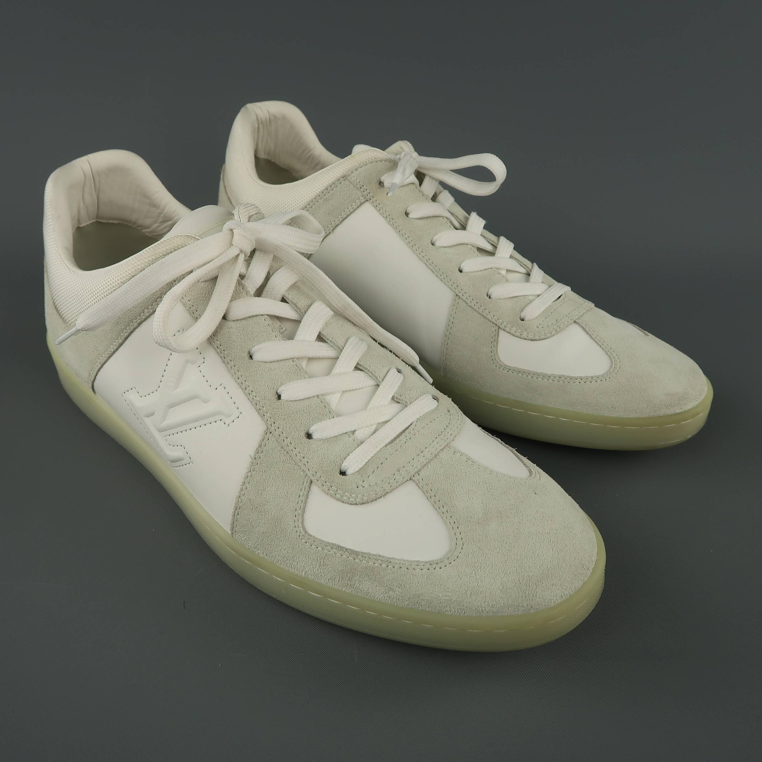 Louis Vuitton sneakers come in white leather with light gray suede panels, LV embossed side, and clear rubber sole. Minor wear. Made in Italy.
 Good Pre-Owned Condition.
Marked: UK 9.5
Outsole: 12 x 4 in.

