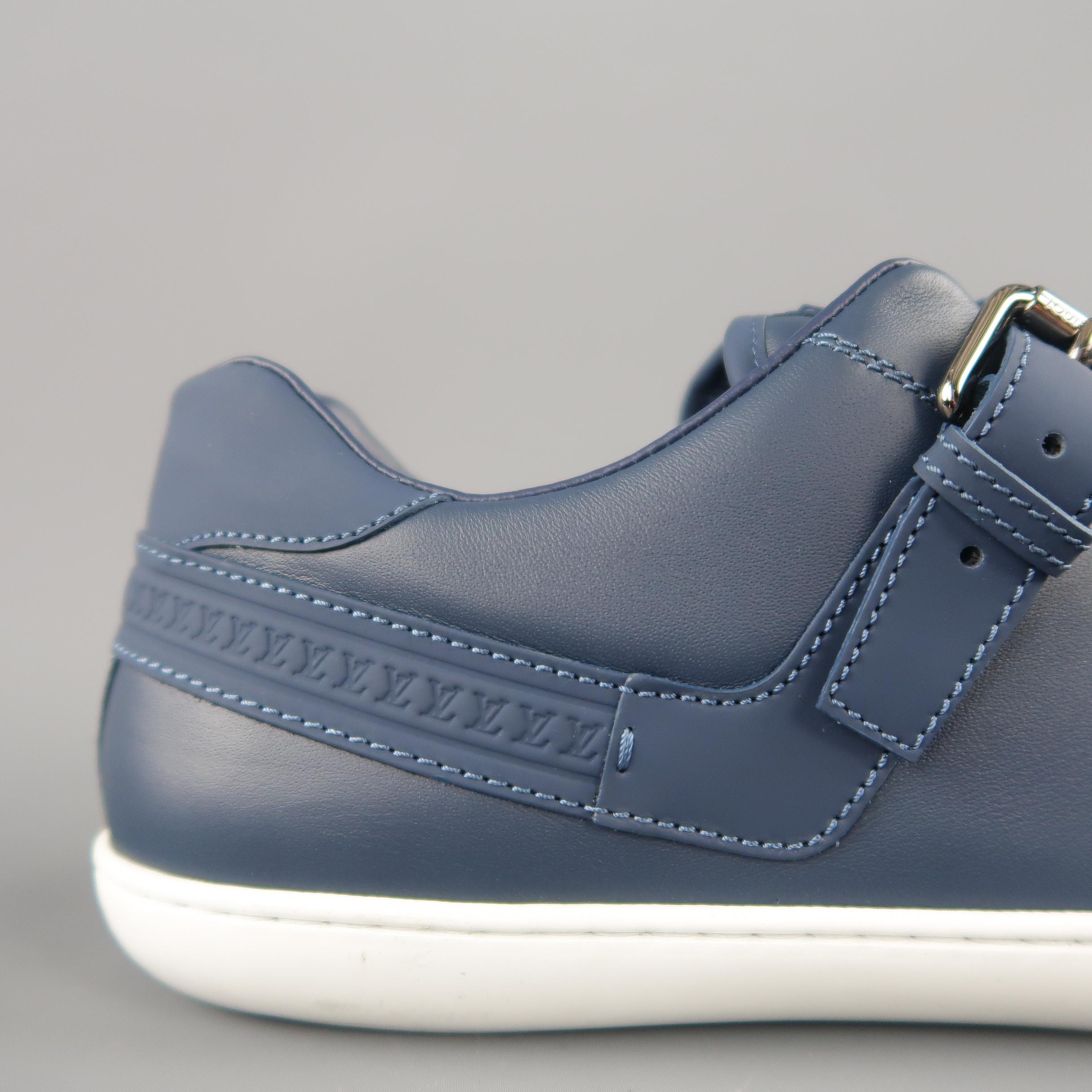 LOUIS VUITTON low top sneakers come in muted navy blue leather with a rubber toe cap, lace up front, white rubber sole, and LV monogram rubber panel and strap with silver tone metal buckle. With box. Made in Italy.
 
Excellent Pre-Owned Condition.
