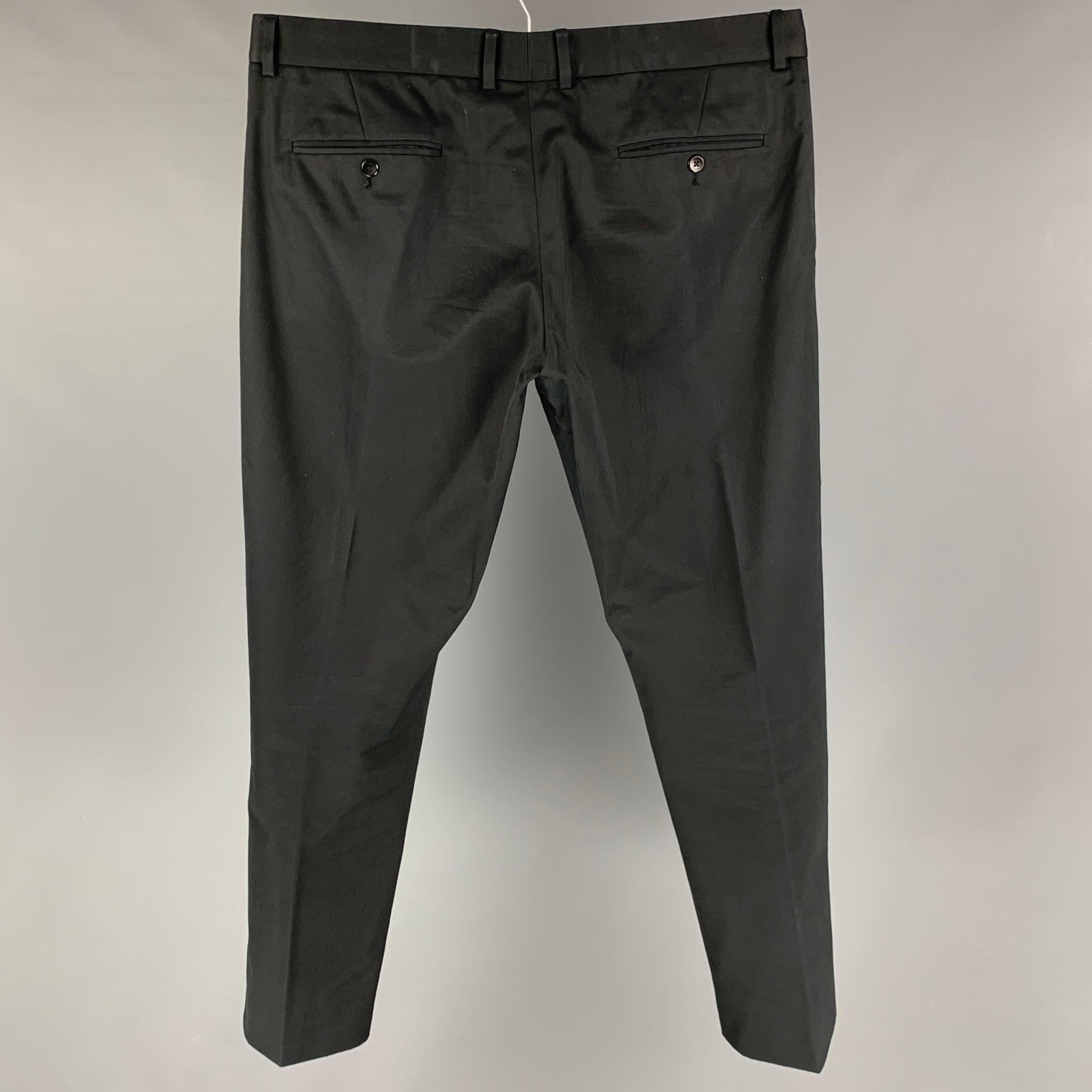 LOUIS VUITTON pants comes in a black cotton featuring a flat front, leather tab, front tab, and a zip fly closure. Made in Italy. 

Very Good Pre-Owned Condition.
Marked: 48

Measurements:

Waist: 36 in.
Rise: 10 in.
Inseam: 33 in. 