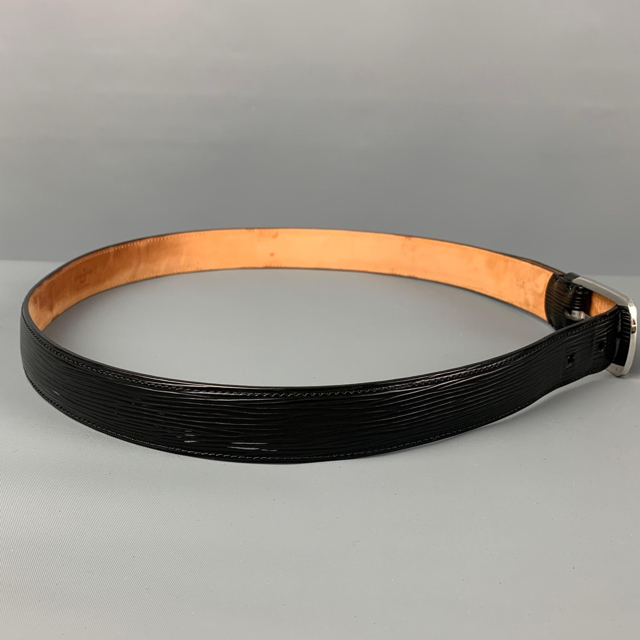 LOUIS VUITTON belt comes in a black textured epi leather featuring a silver tone buckle. Made in France. 

Very Good Pre-Owned Condition. Patina on inside of leather.
Marked: 95/38

Length: 42 in.
Width: 1 in.
Fits: 34.5 - 37.5 in.
Buckle: 2 in. 