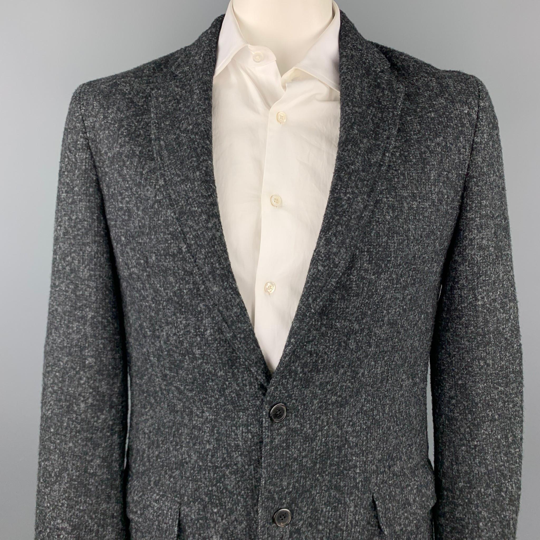 LOUIS VUITTON sport coat comes in a black & grey textured wool / alpaca with a half liner featuring a notch lapel, flap pockets, and a two button closure. Made in Italy.

Excellent Pre-Owned Condition.
Marked: IT 54
Original Retail Price: