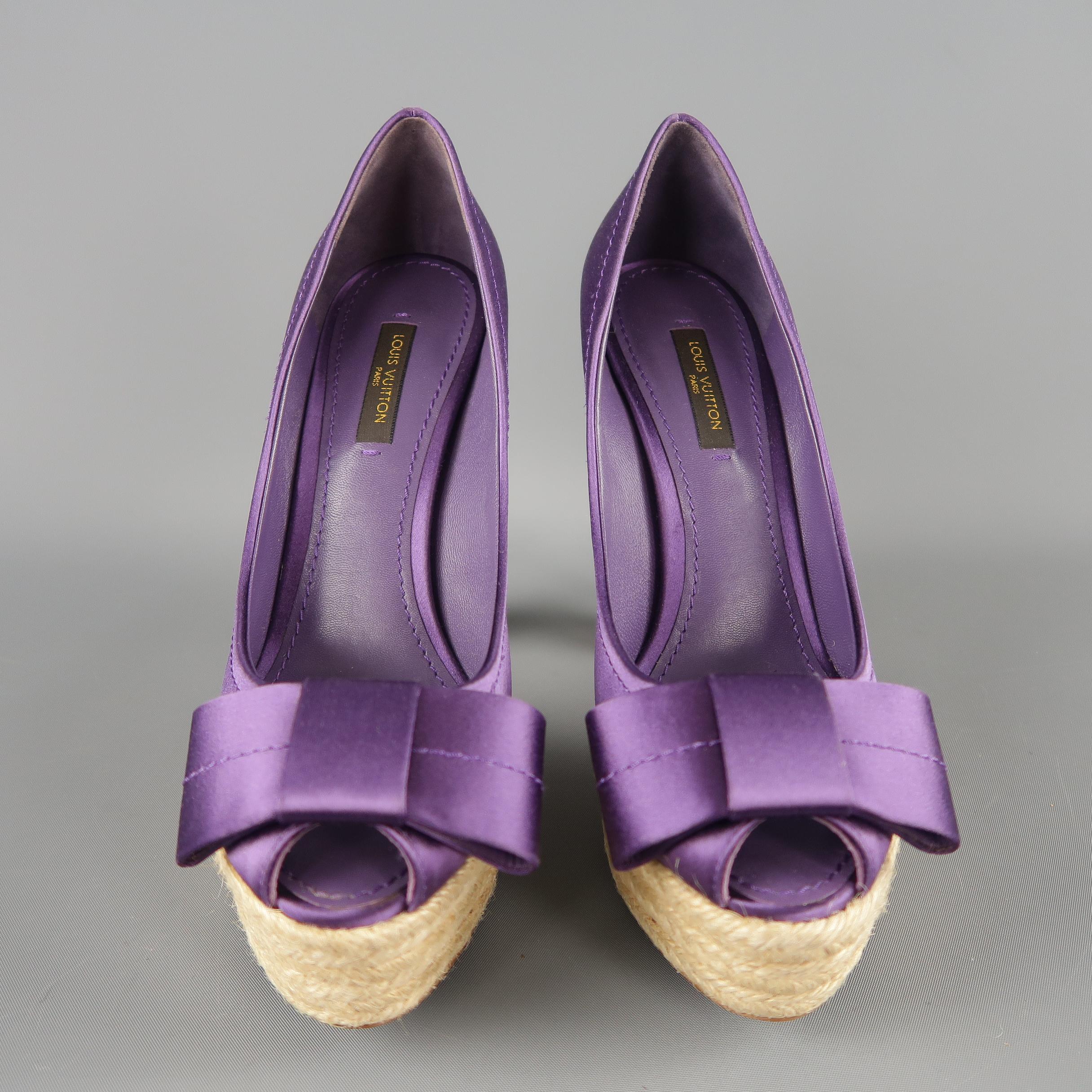 LOUIS VUITTON pumps come in purple silk satin with a peep toe detailed with a bow, gold tone metal monogram heel detail, and braided espadrille platform and chunky heel. Made in Italy.
 
New without Tags.
Marked: IT 36
 
Heel: 5 in.
Platform: 1.25