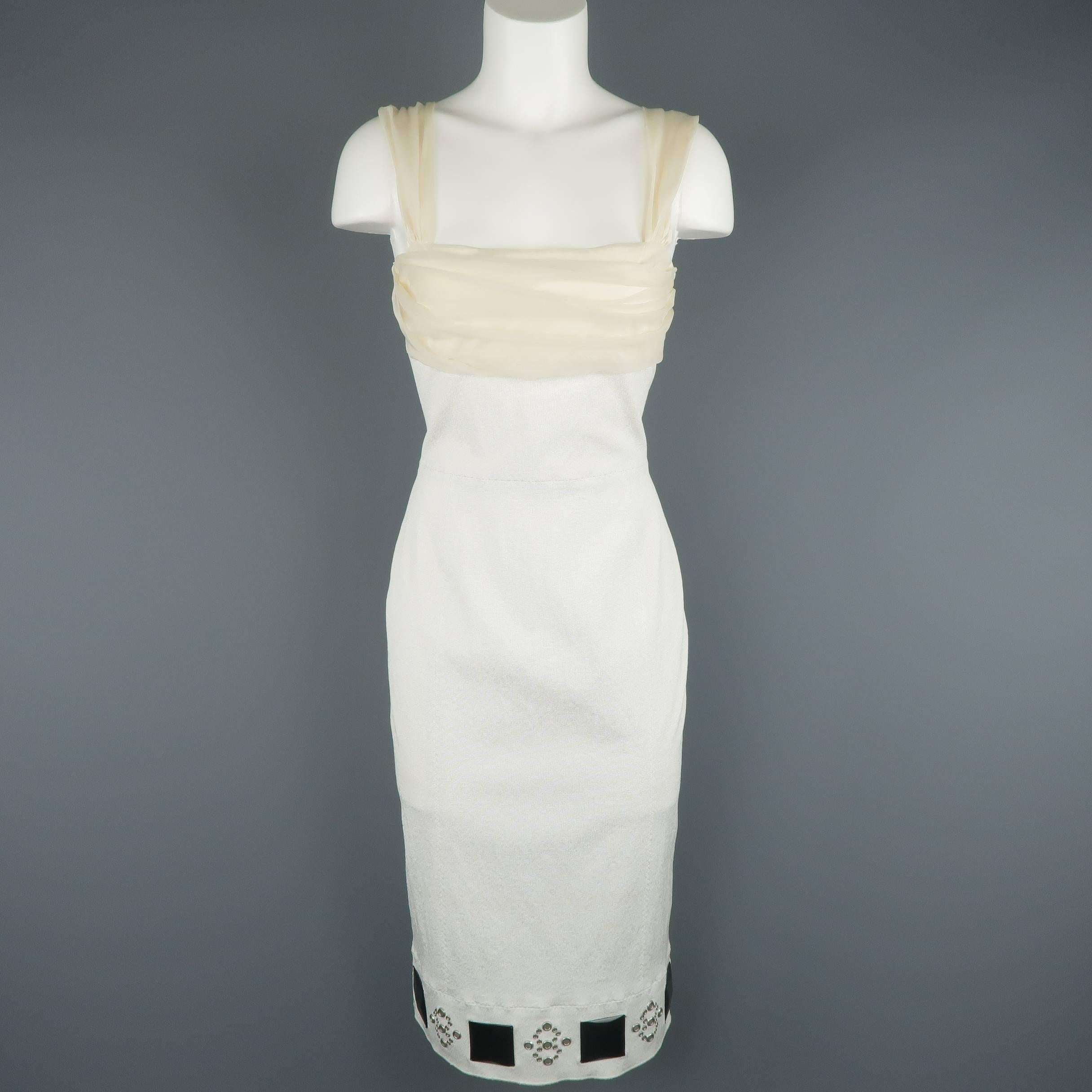 Louis Vuitton cocktail dress comes in white stretch crepe and features beige pleat gathered bust and straps, embellished hem with black studs and silver tone grommets, and detachable belt with tulle ruffle accents. Imperfection on belt stud.  Made