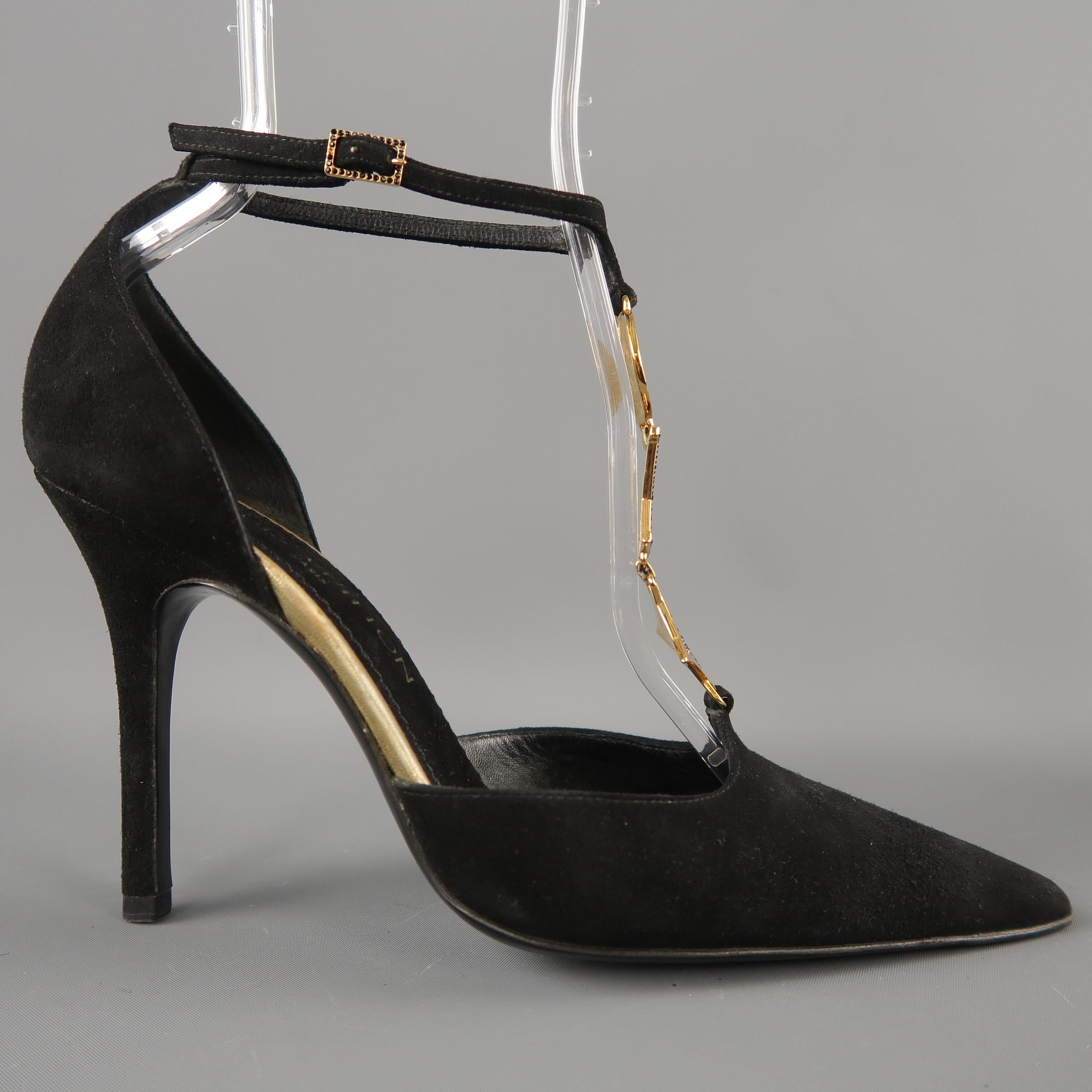LOUIS VUITTON D'orsay pumps come in black suede with a pointed toe, covered stiletto heel, and ankle strap with gold tone metal rhinestone studded monogram charm T strap. Made in Italy. Retail price $ 1,000.00. 
 
Very Good Pre-Owned