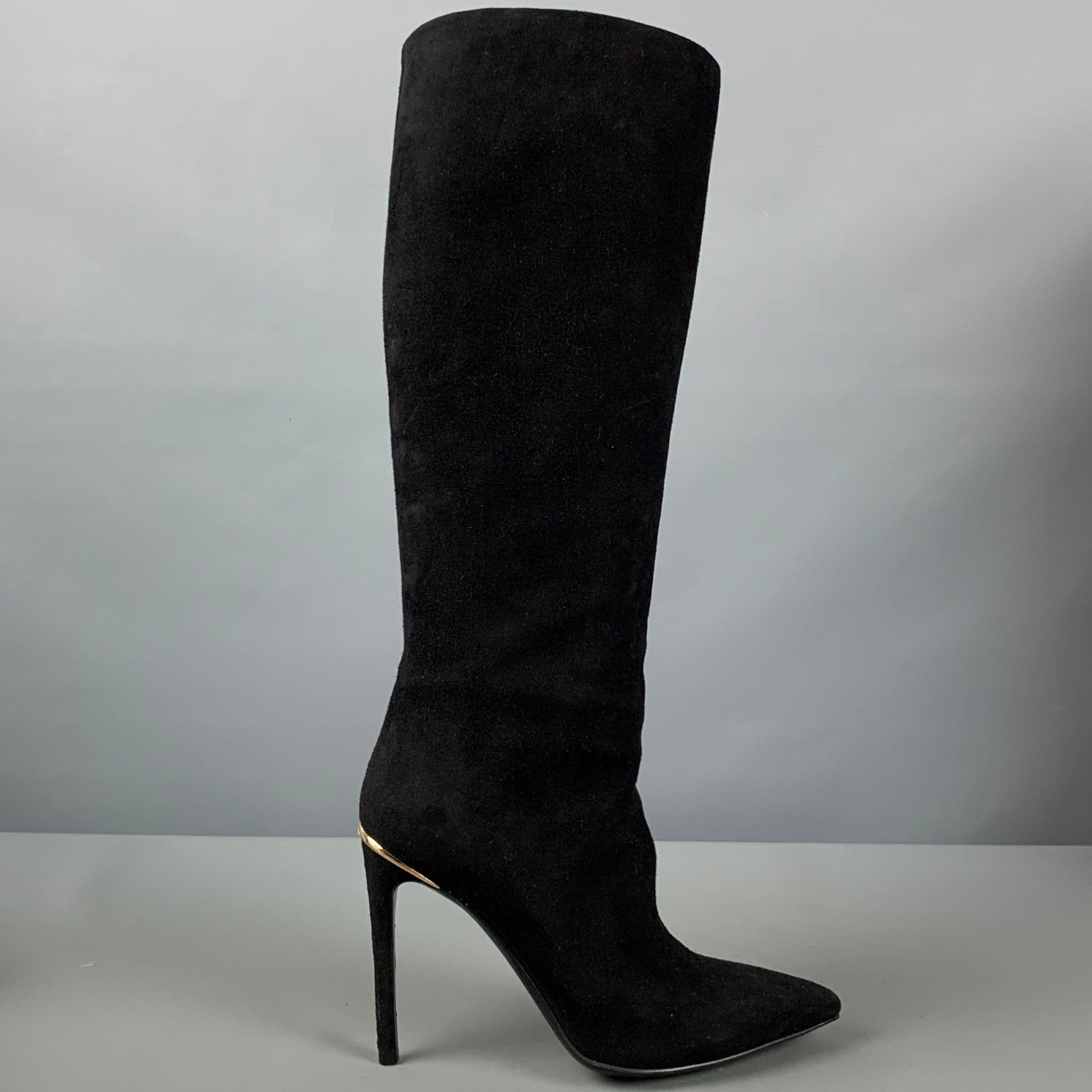 LOUIS VUITTON boots in a black suede featuring a knee high pull on style, gold tone heel detail, and pointed toe. Made in Italy.Very Good Pre-Owned Condition. 

Marked:   IT 37 

Measurements: 
  Length: 8.5 inches Width: 3 inches Height: 18.5