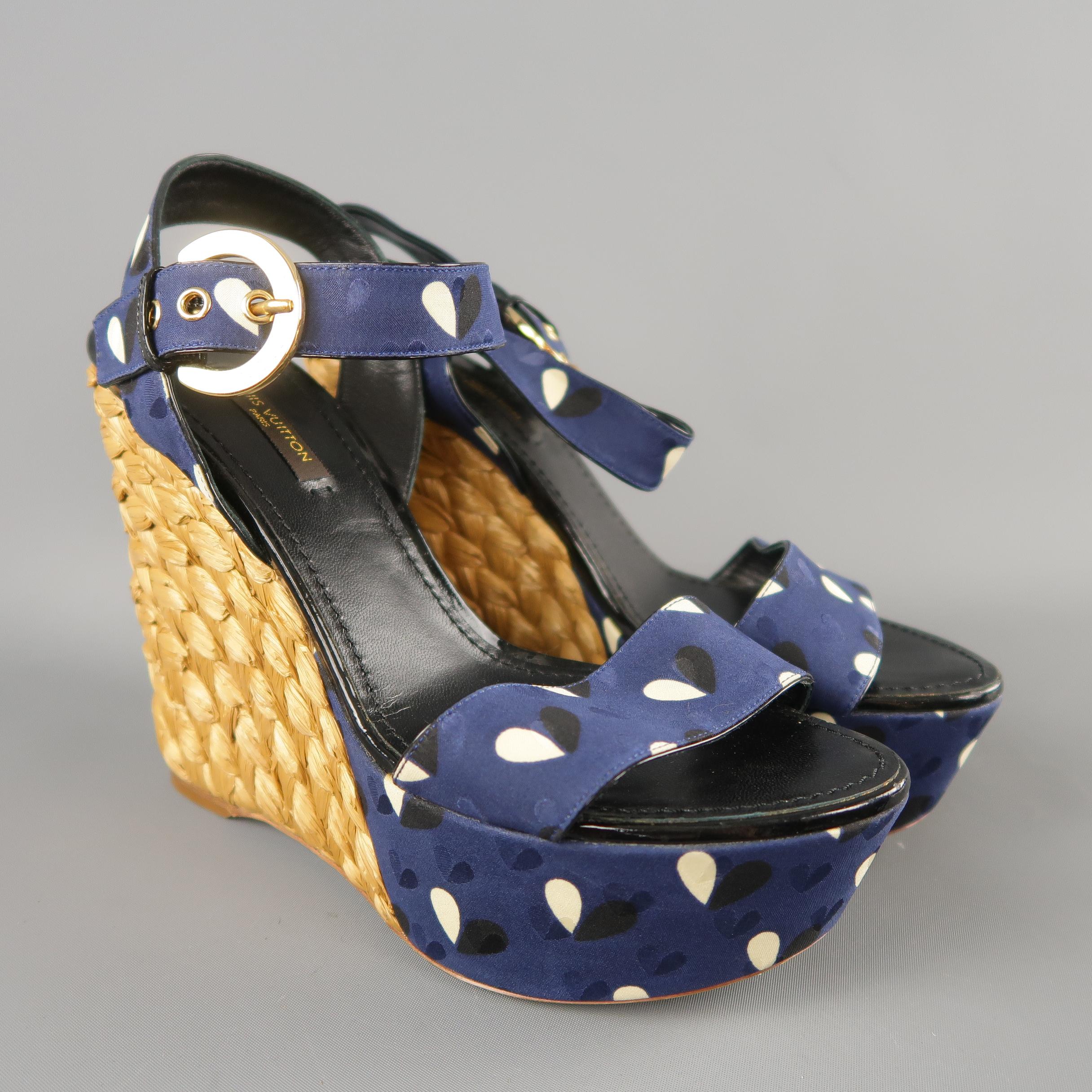 LOUIS VUITTON sandals come in navy printed satin with thick straps, ankle harness with gold tone engraved buckle, and thick braided platform wedge heel. Made in Italy.
 
New without Tags.
Marked: IT 37
 
Heel: 5 in.
Platform: 1.5 in.