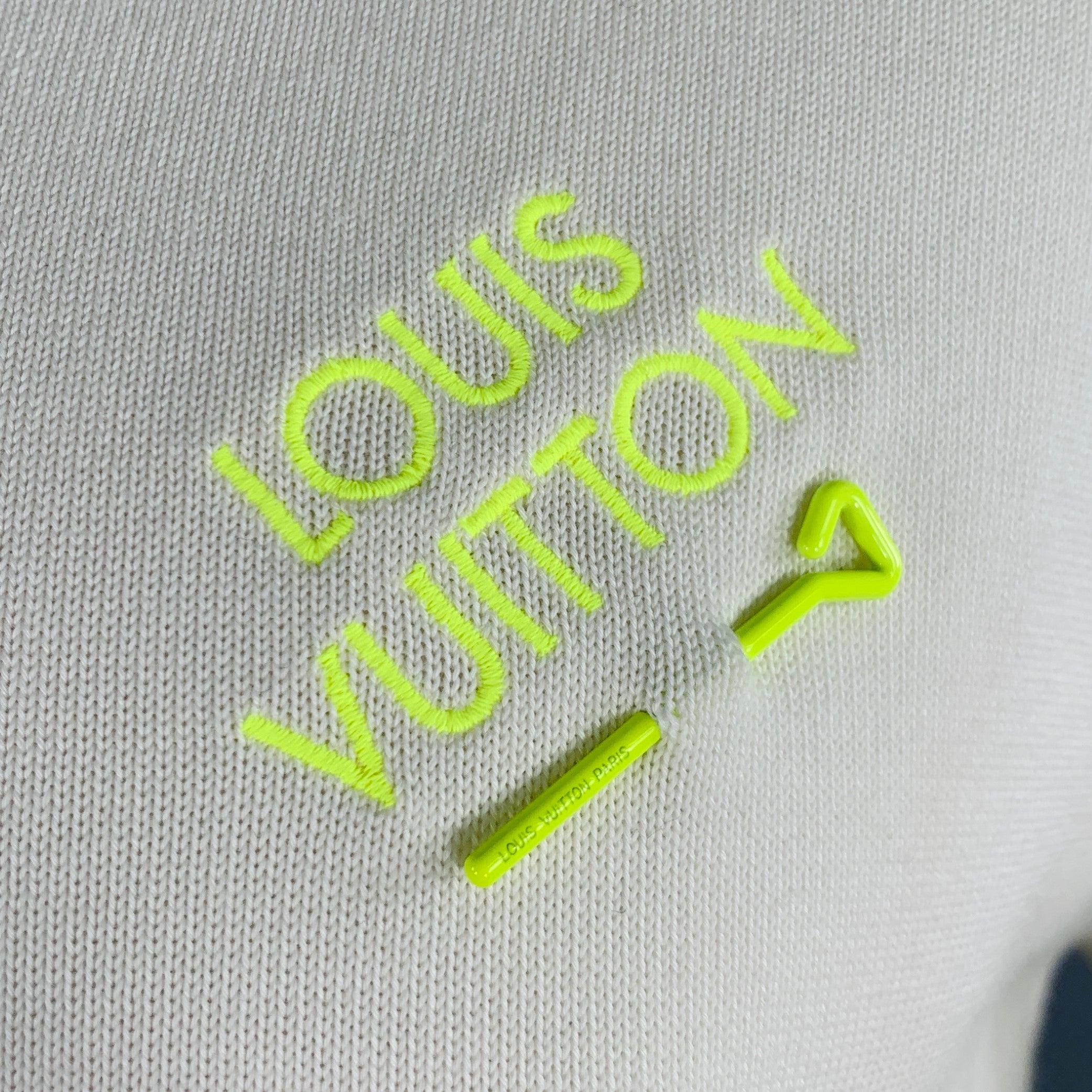 LOUIS VUITTON t-shirt
in a beige cotton knit featuring neon yellow logo with metal detail, short sleeves, and crew neck. Made in Italy.Very Good Pre-Owned Condition. Multiple minor marks. 

Marked:   L 

Measurements: 
 
Shoulder: 21.5 inches Chest: