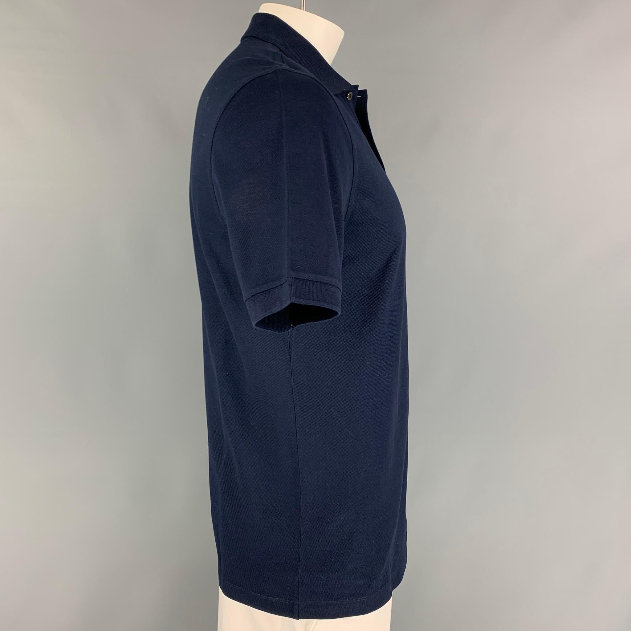 LOUIS VUITTON polo comes in a navy cotton featuring a embroidered logo, spread collar, and a half buttoned closure. Made in Italy. 

Excellent Pre-Owned Condition.
Marked: L

Measurements:

Shoulder: 18 in.
Chest: 40 in.
Sleeve: 10 in.
Length: 28