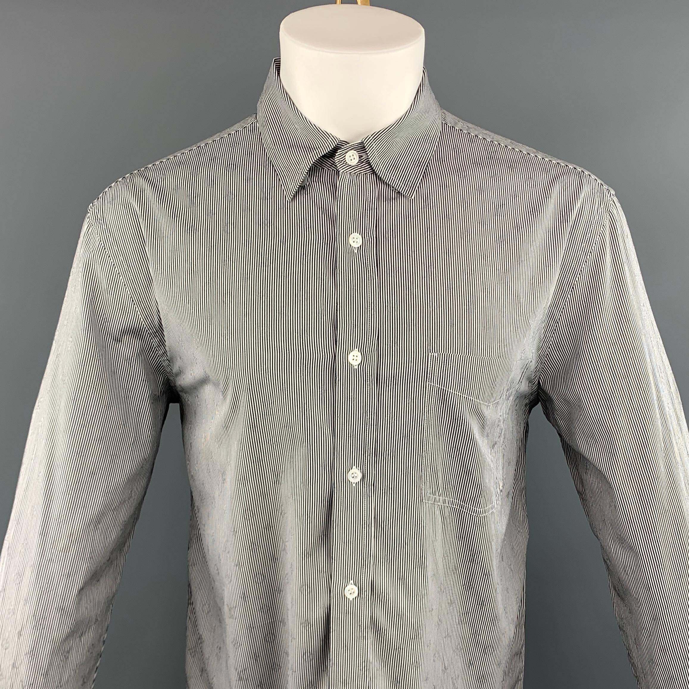 LOUIS VUITTON long sleeve shirt comes in a white and black striped cotton featuring a monogram detail throughout, button up style, spread collar, and a front patch pocket. Made in Italy.
 
Excellent Pre-Owned Condition.
Marked: L
 
Measurements:
