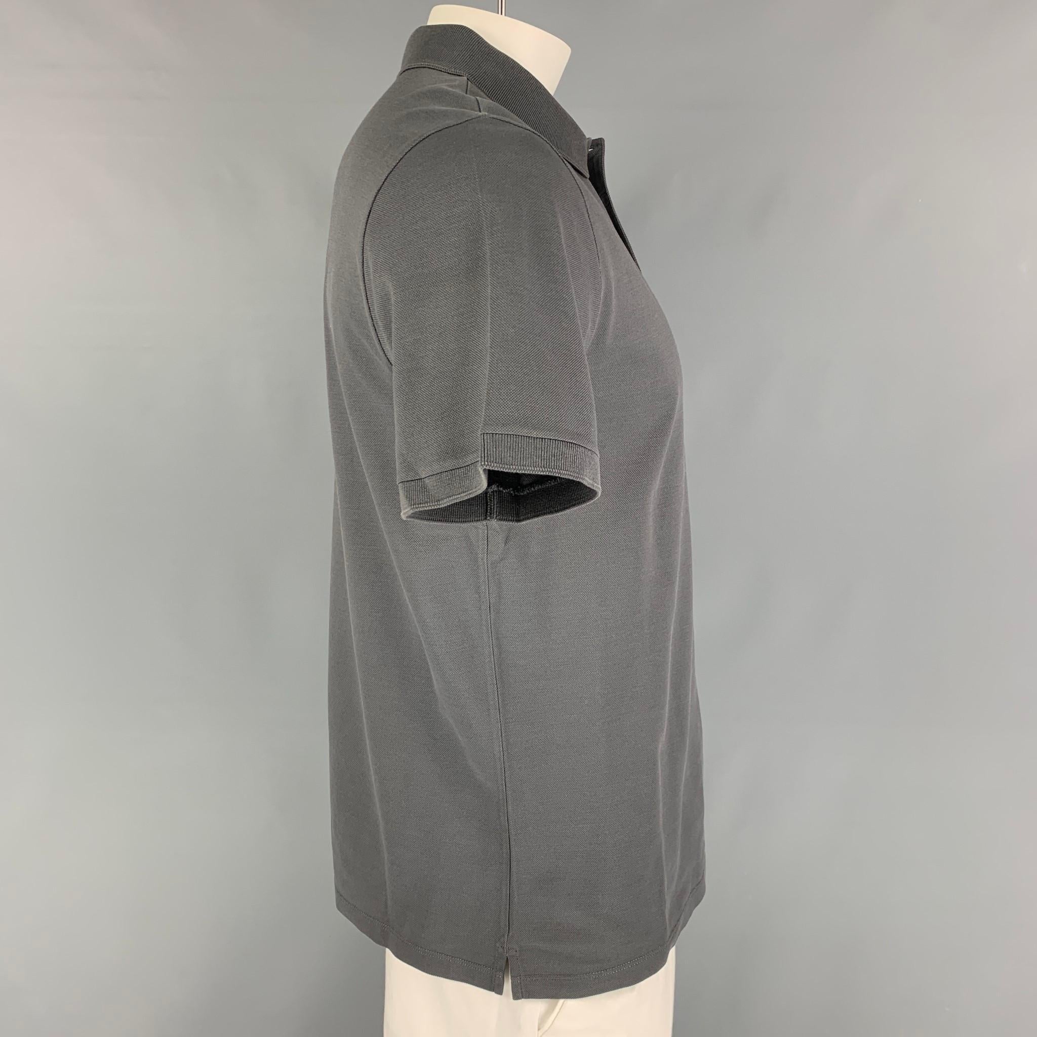 LOUIS VUITTON polo comes in a grey cotton featuring a embroidered logo, spread collar, and a half buttoned closure. Made in Italy. 

Excellent Pre-Owned Condition.
Marked: XL

Measurements:

Shoulder: 18.5 in.
Chest: 42 in.
Sleeve: 10 in.
Length: