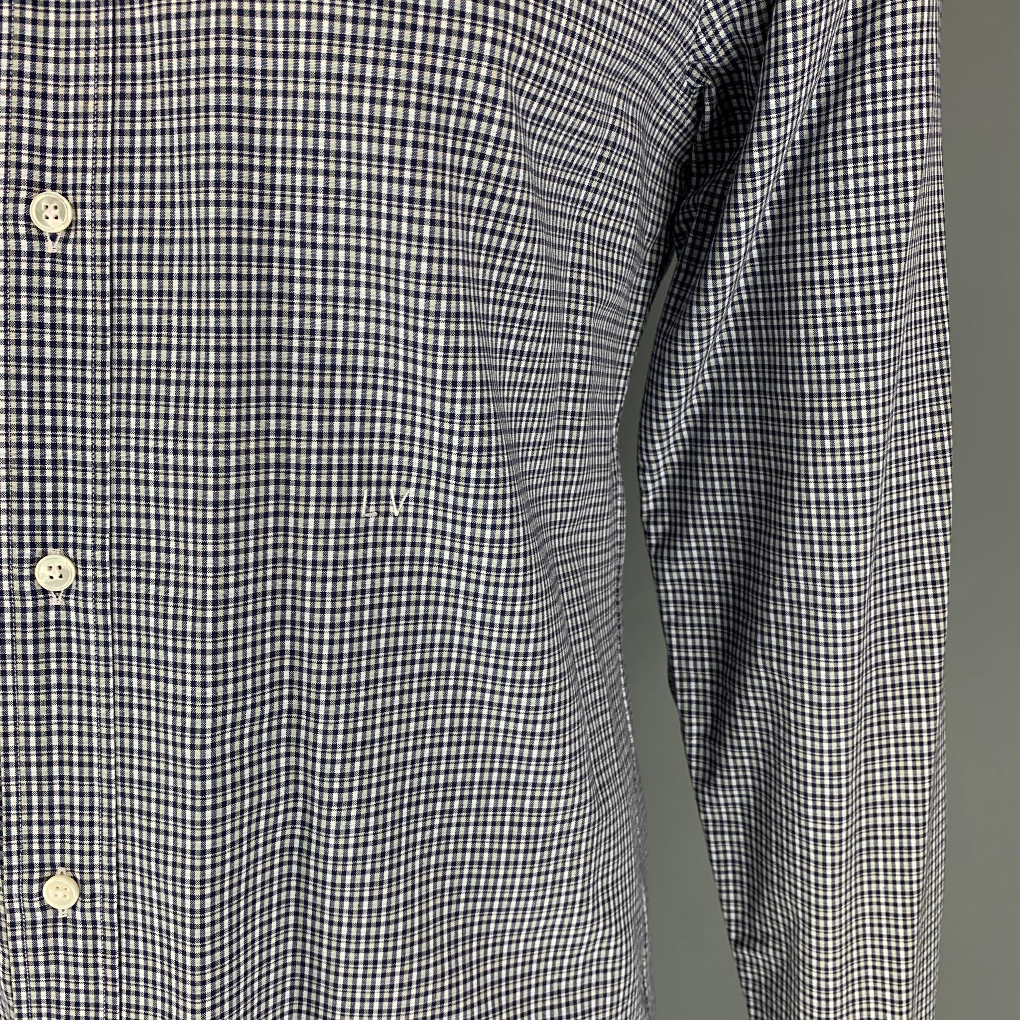 LOUIS VUITTON long sleeve shirt comes in a white & navy plaid cotton featuring a spread collar, small embroidered logo, and a button up closure. Made in Italy. 

Excellent Pre-Owned Condition.
Marked: XL

Measurements:

Shoulder: 18.5 in.
Chest: 44